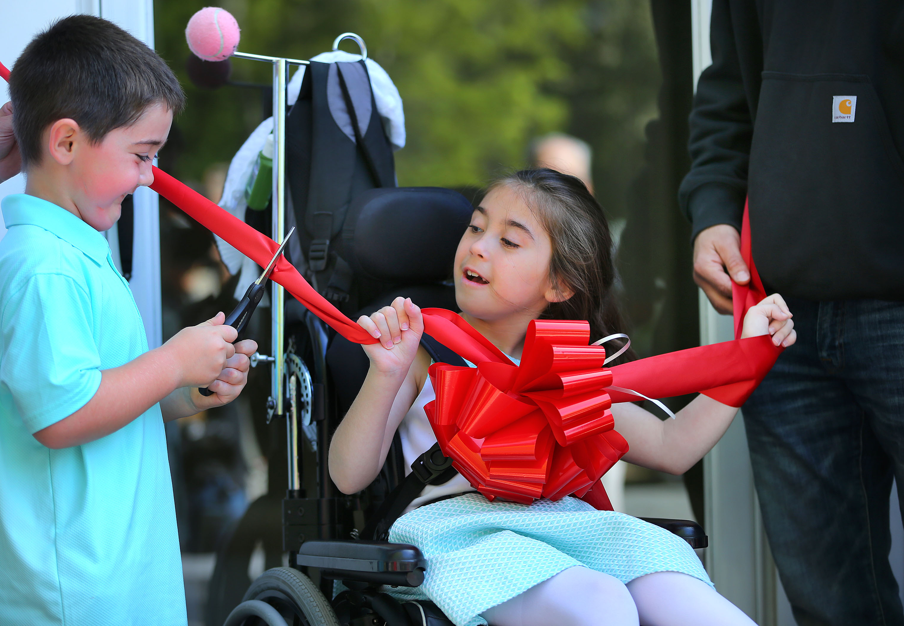 Abby and her 6-year-old brother, Thomas, cut the ribbon.