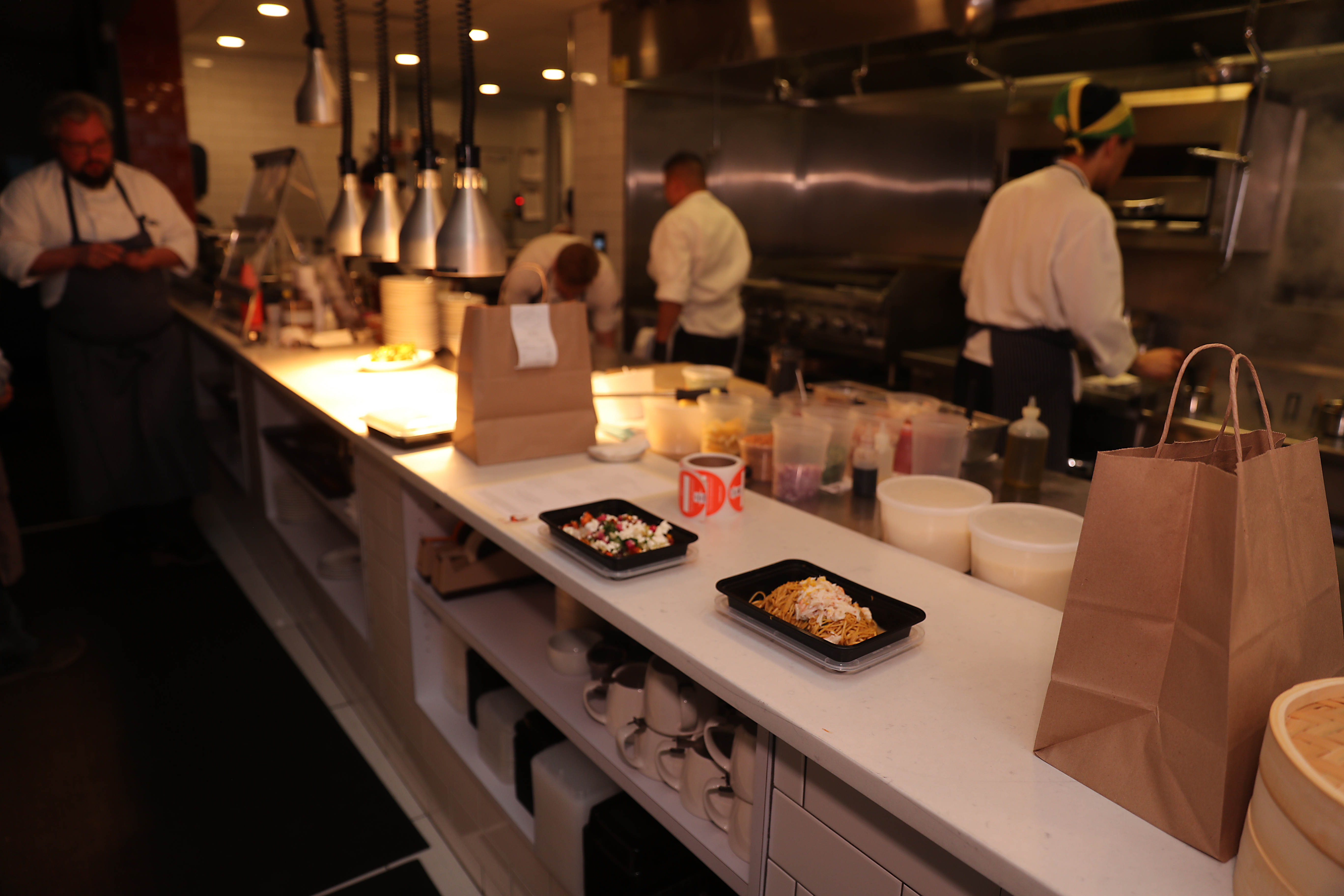 A take-out meal awaits delivery service on the counter at Bar Mezzana.