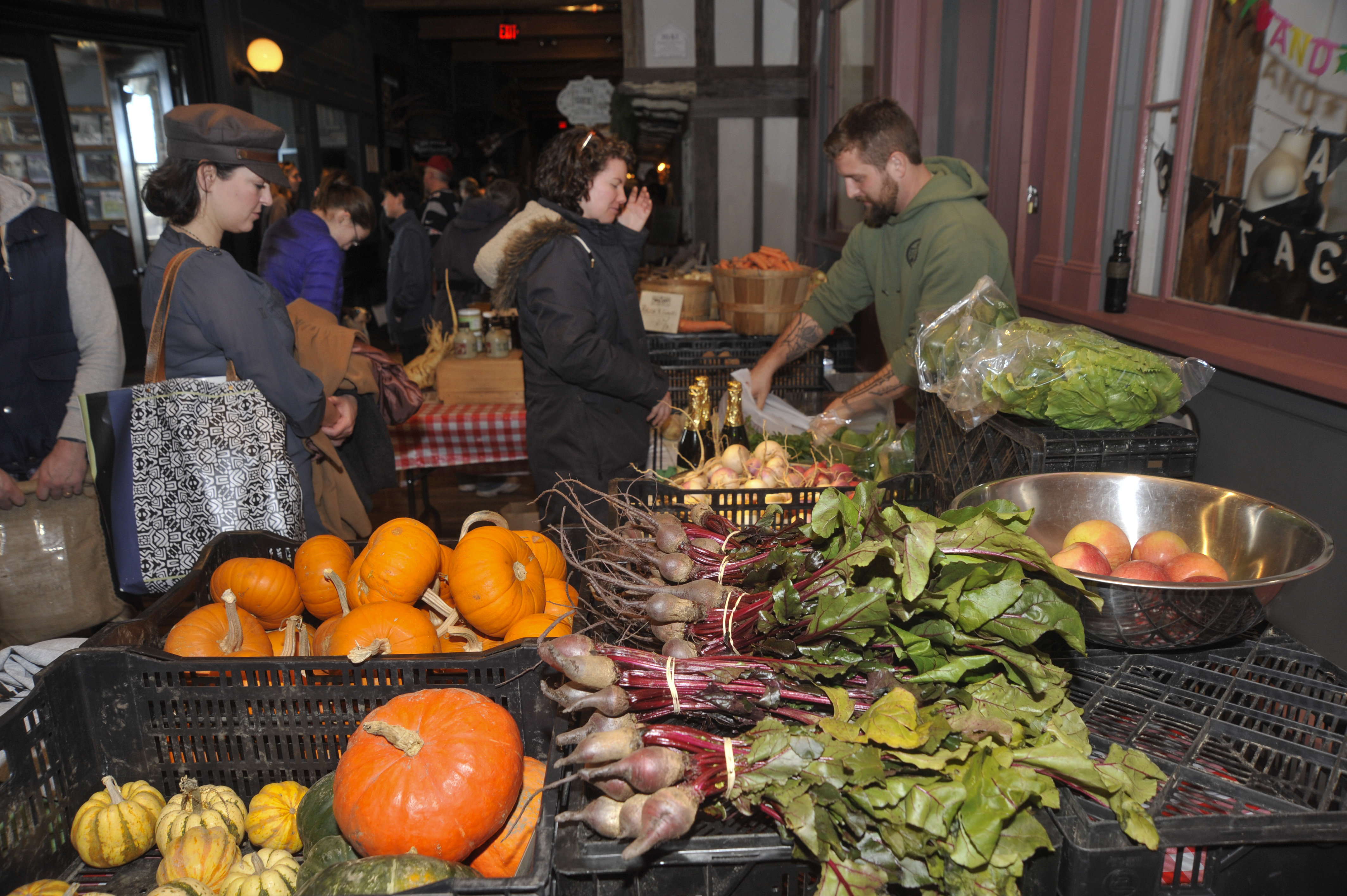 Customers lined up last fall to buy fresh produce at the Mill City Grows farmers market booth in Lowell.