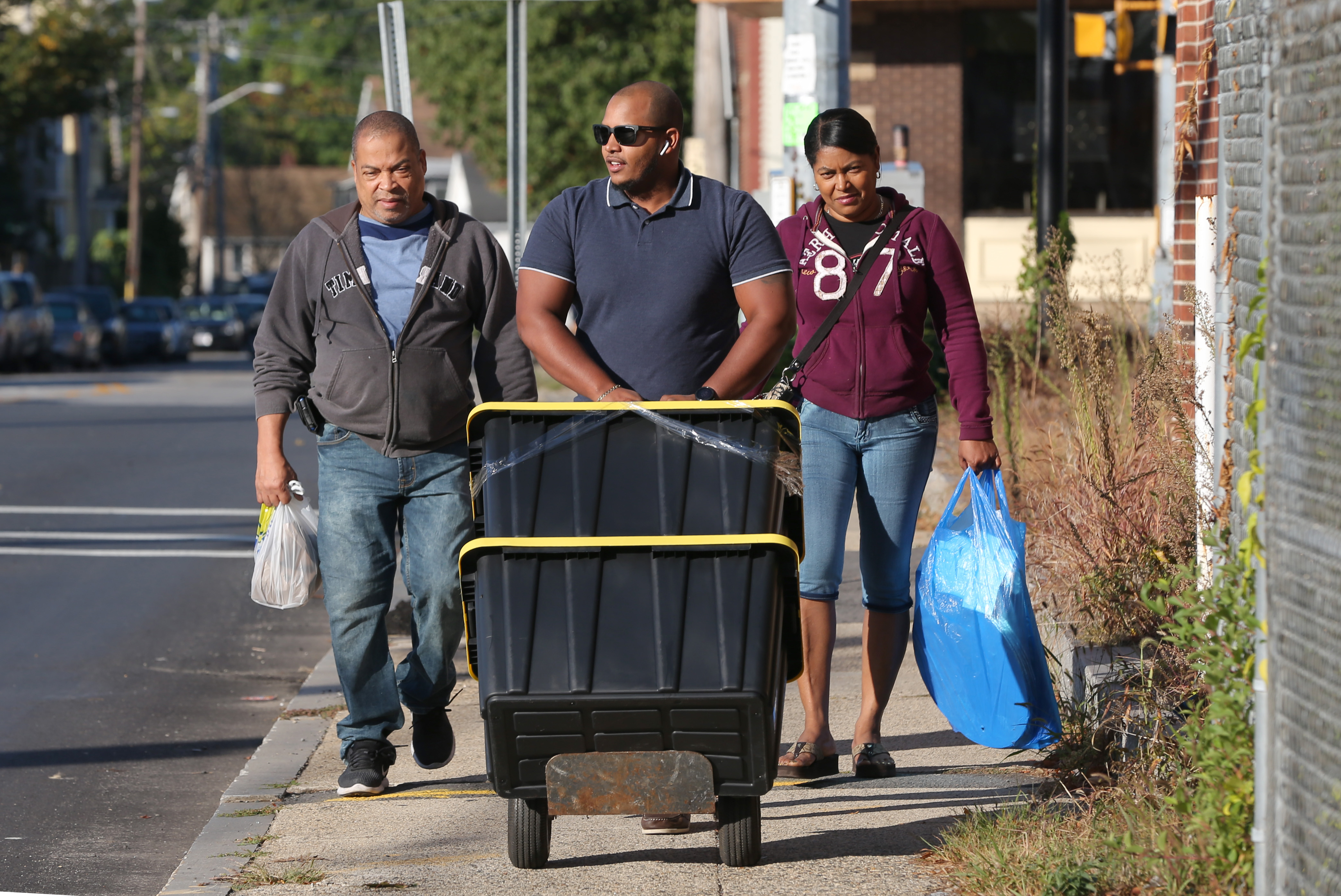 From left ot right: Luis Cedeno, Francisco Santana and Dominga Garcia moved perishable goods from his store, Bizcochos Y Mas on South Broadway in Lawrence.