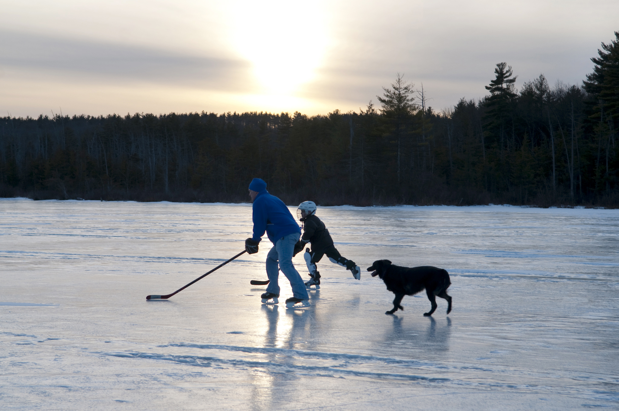 Atkinson and another nephew, Owen Bower, chase a puck.