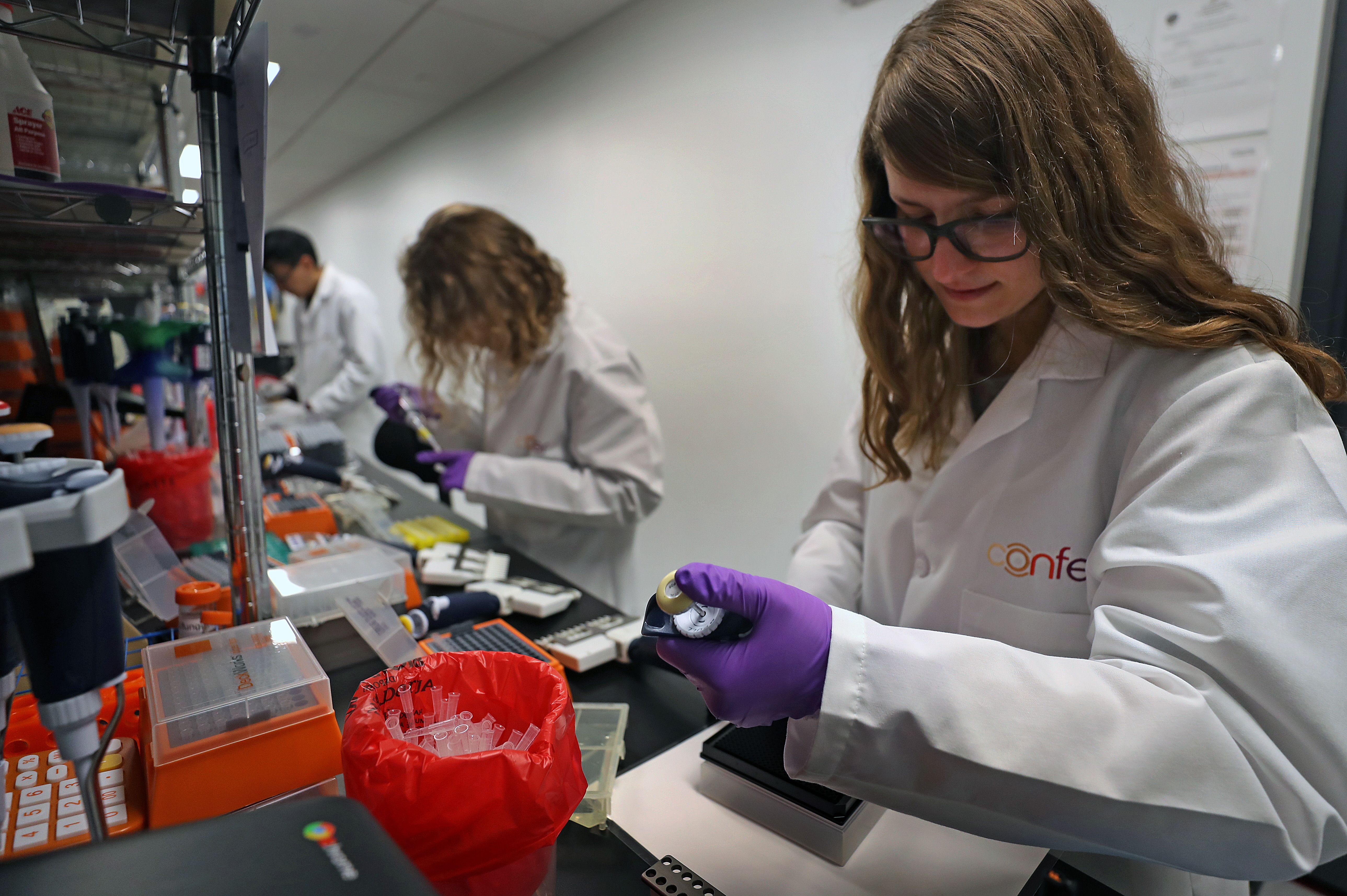 Scientist Jess Miller (right) at work in the lab at Confer Health in Charlestown.