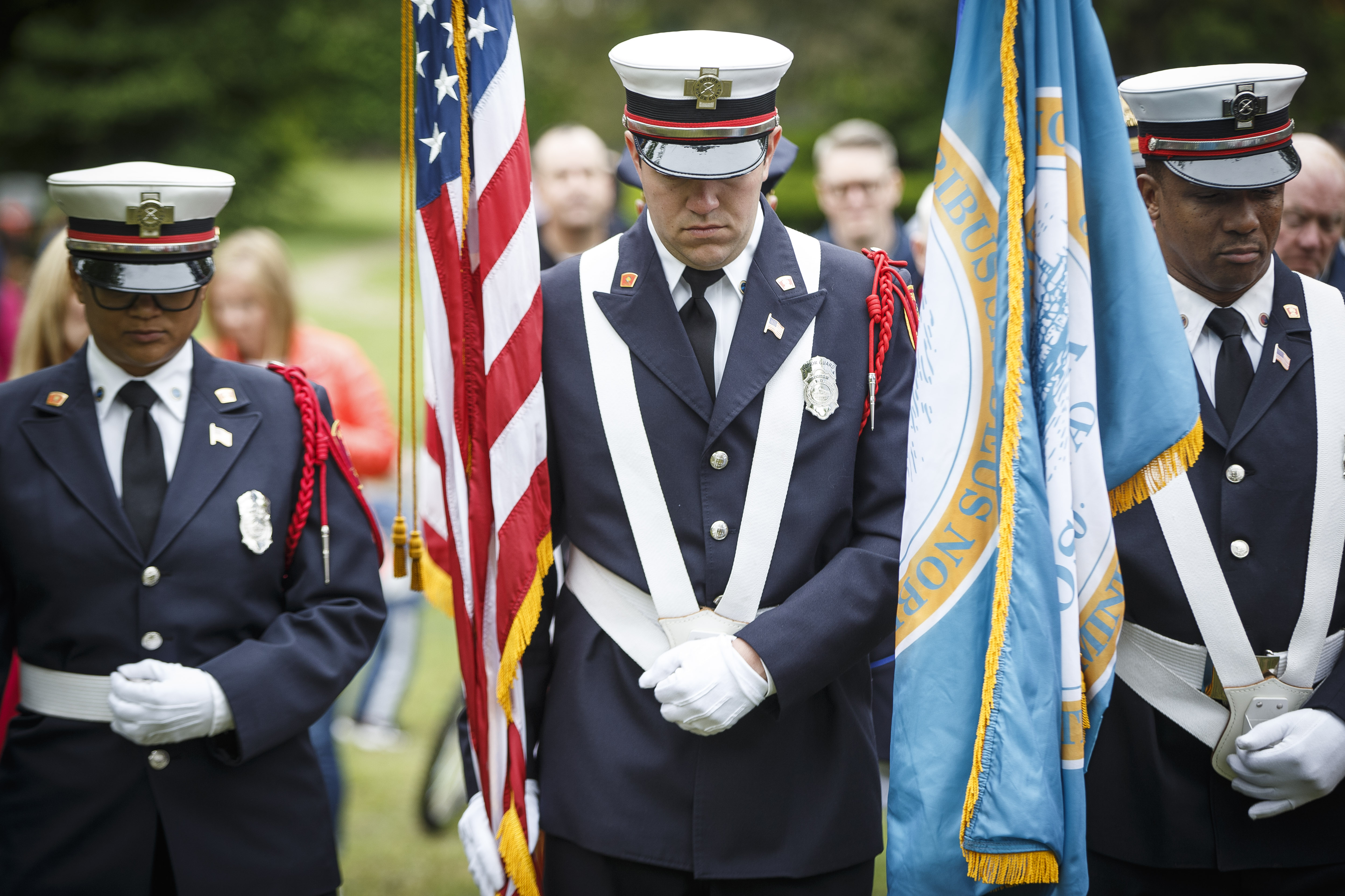 Members of the Boston Fire Department's honor guard bowed their heads.