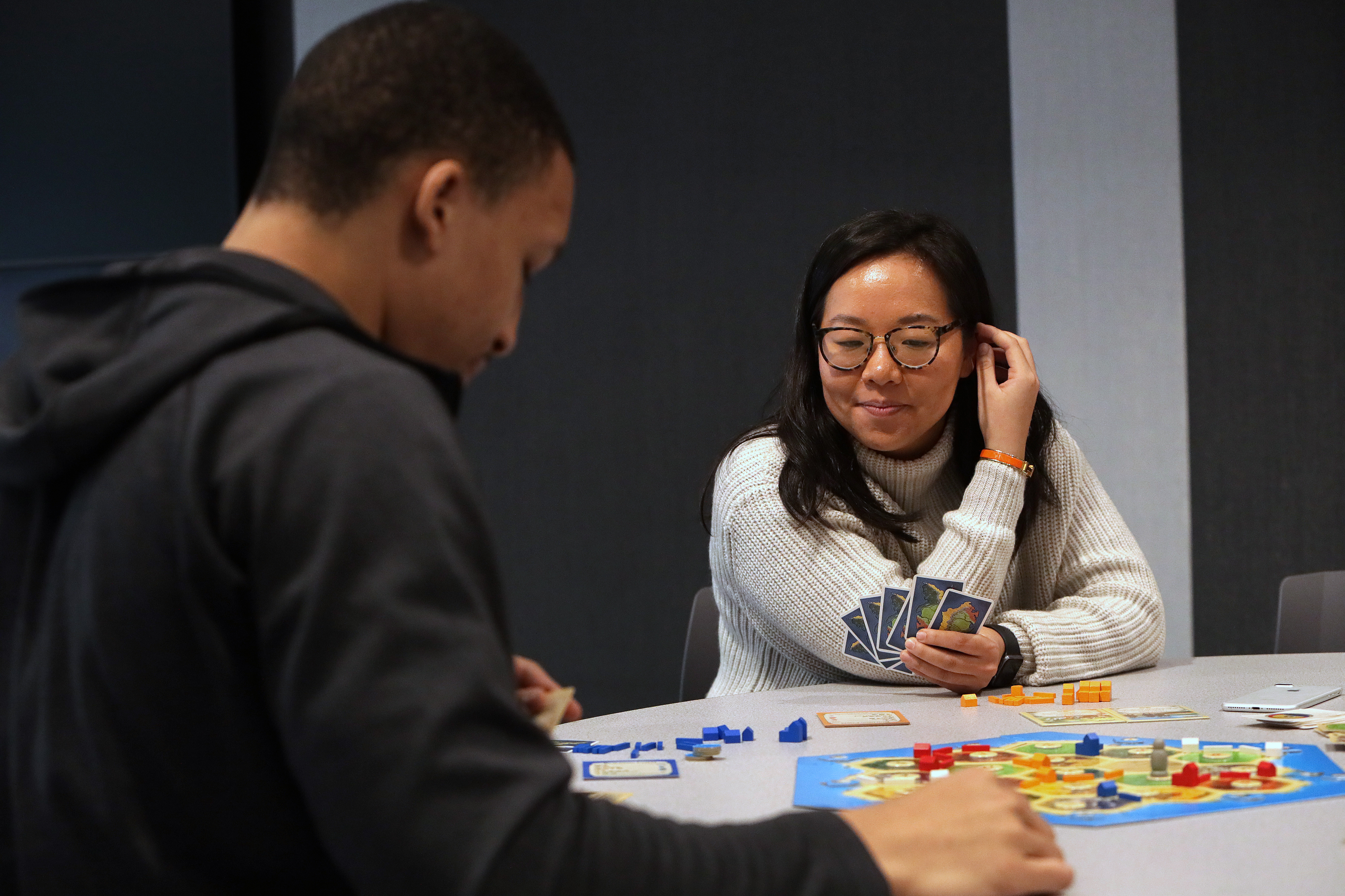 Globe reporter Nicole Yang, a novice at Settlers of Catan, surveys the board.