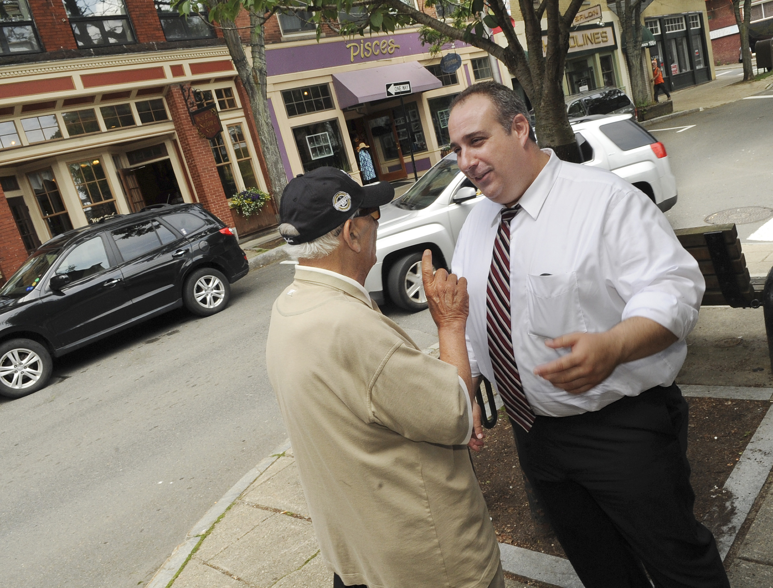 Campanello (right) talked with resident Frank Iacono on Main Street in Gloucester.