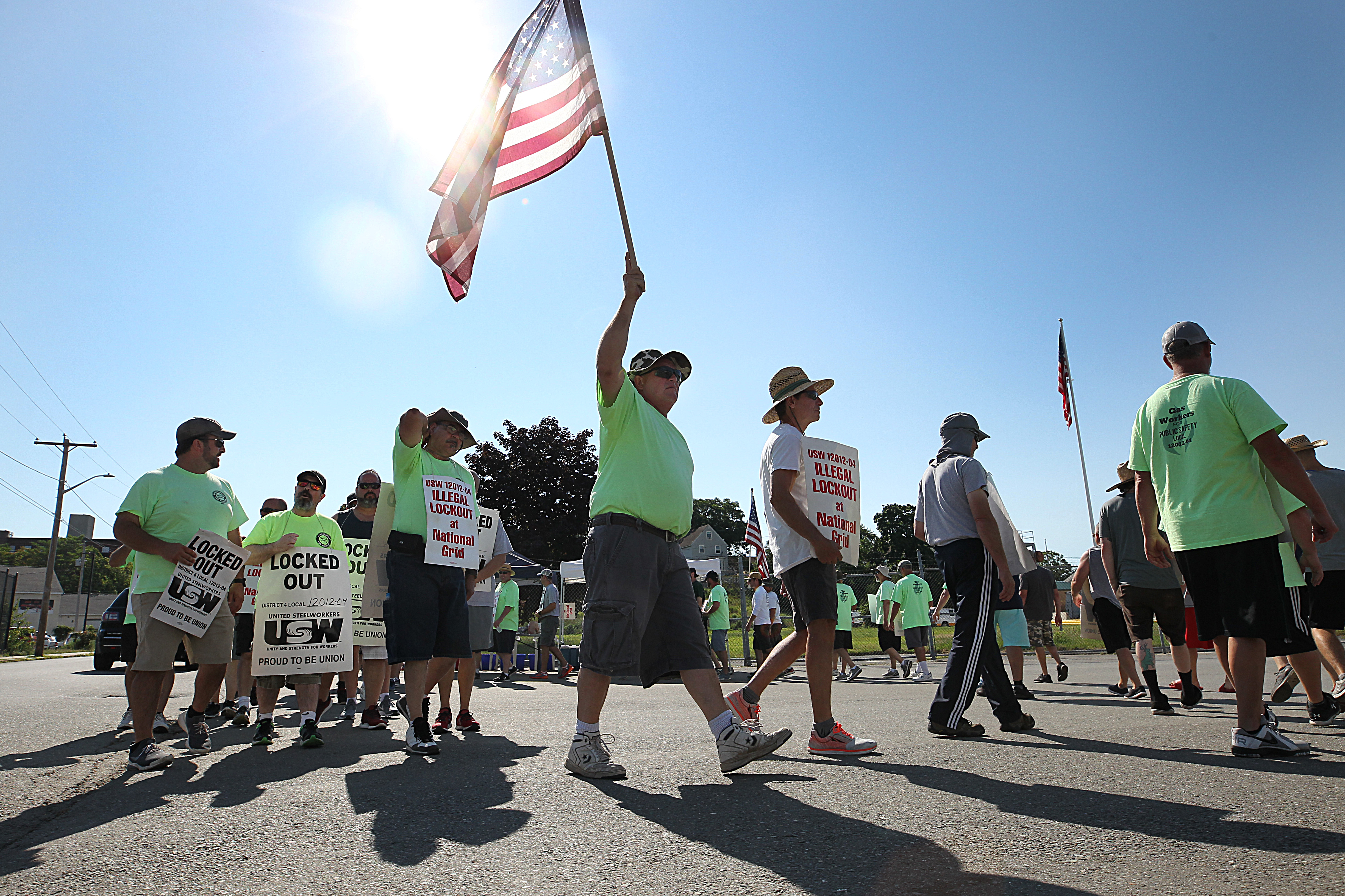 About 1,250 National Grid workers are entering their third week of being locked out after contract negotations stalled, with no paychecks or health care coverage. On Tuesday, they picketed at National Grid’s facility on Rock Street in Lowell.