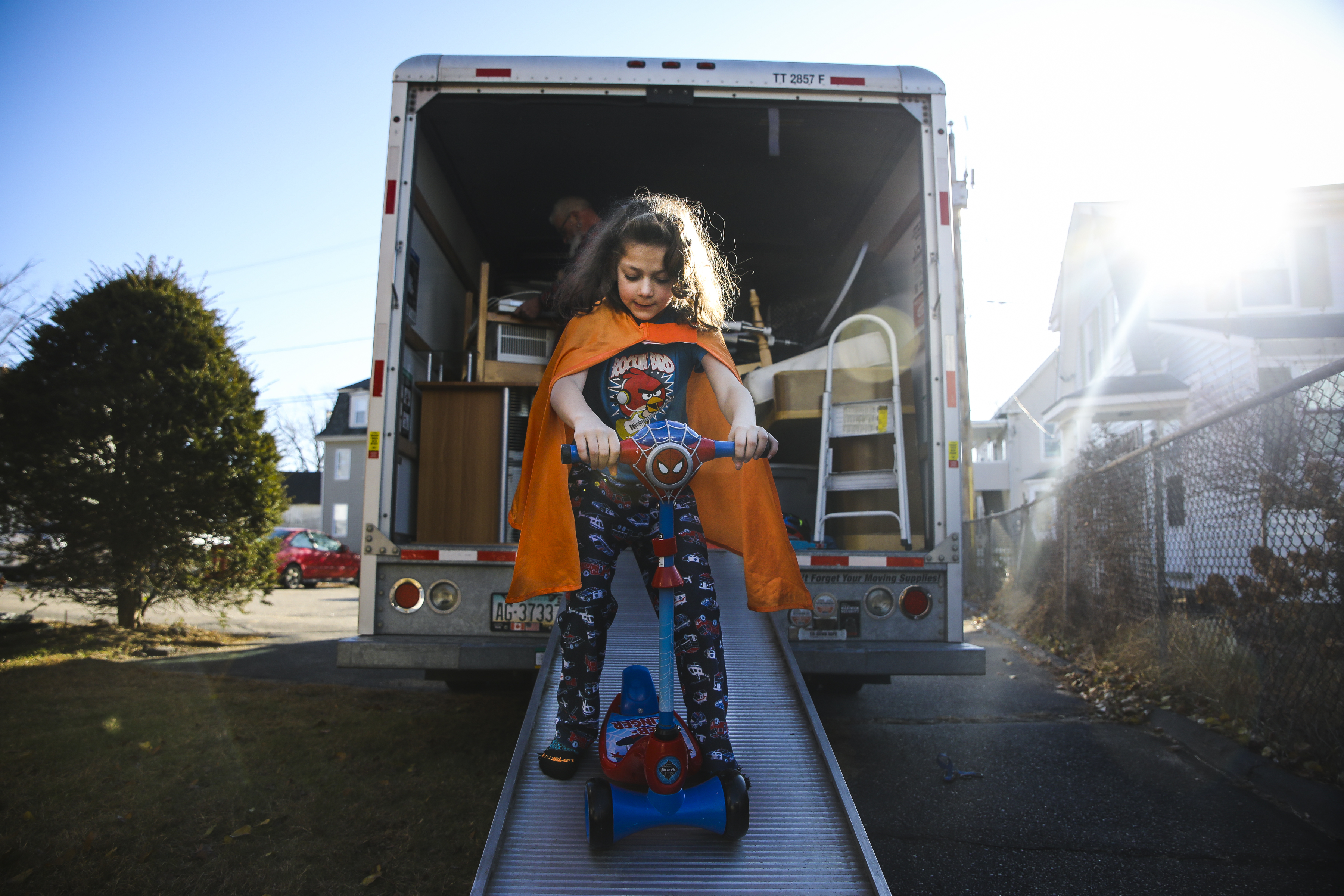 Evan rode his scooter down the ramp of the moving truck while friends and family helped the Lupiens move into their new apartment in New Hampshire. The family had been homeless since July, with most of the children's toys in storage, and Evan was excited to be reunited with his scooter.