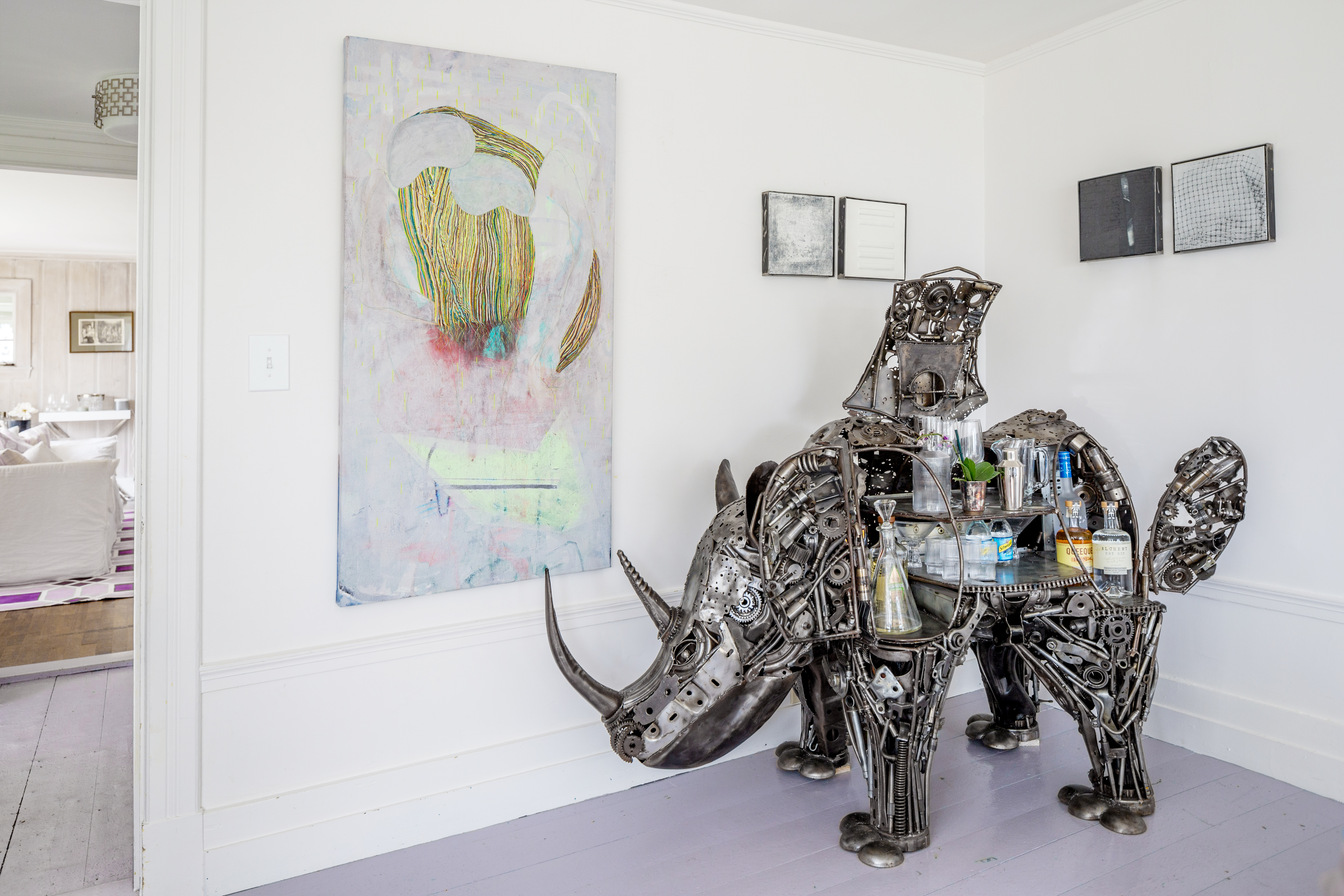 Above the rhinoceros-shaped bar are pieces from last year’s Maine College of Art Summer Art Sale fund-raiser, an abstract painting by Maia Snow and small encaustic works by Dietlind Vander Schaaf.