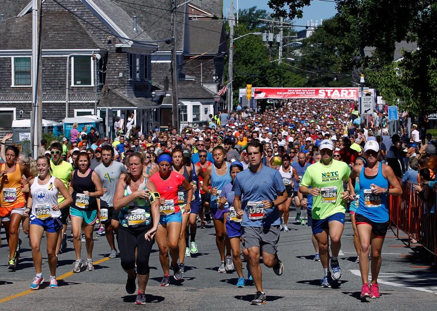 Runners take off from the starting line of the Falmouth Road Race in Woods Hole.