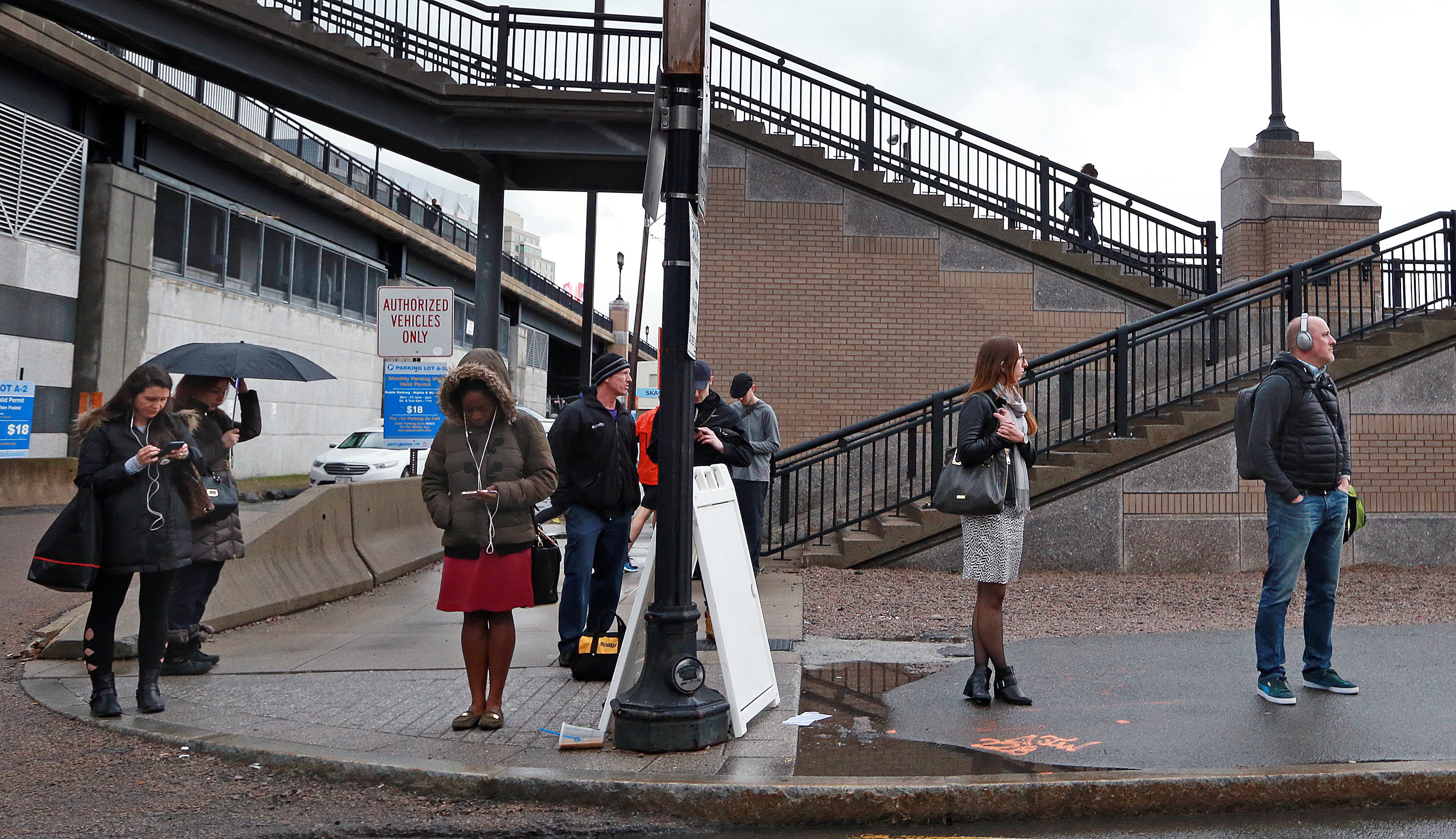 People waited for buses outside of the MBTA Silver Line station on Congress Street.