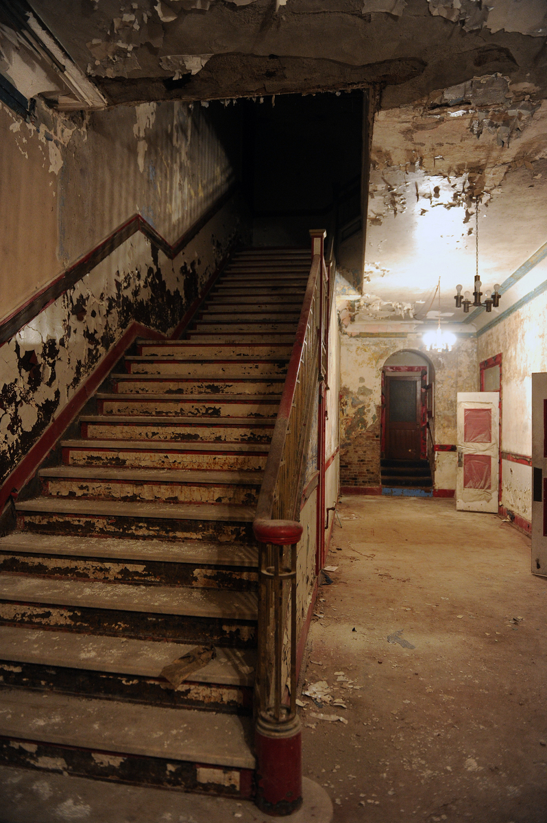 Although the theater is mainly a shell, some historic features remain, including marble stairs with brass railings.