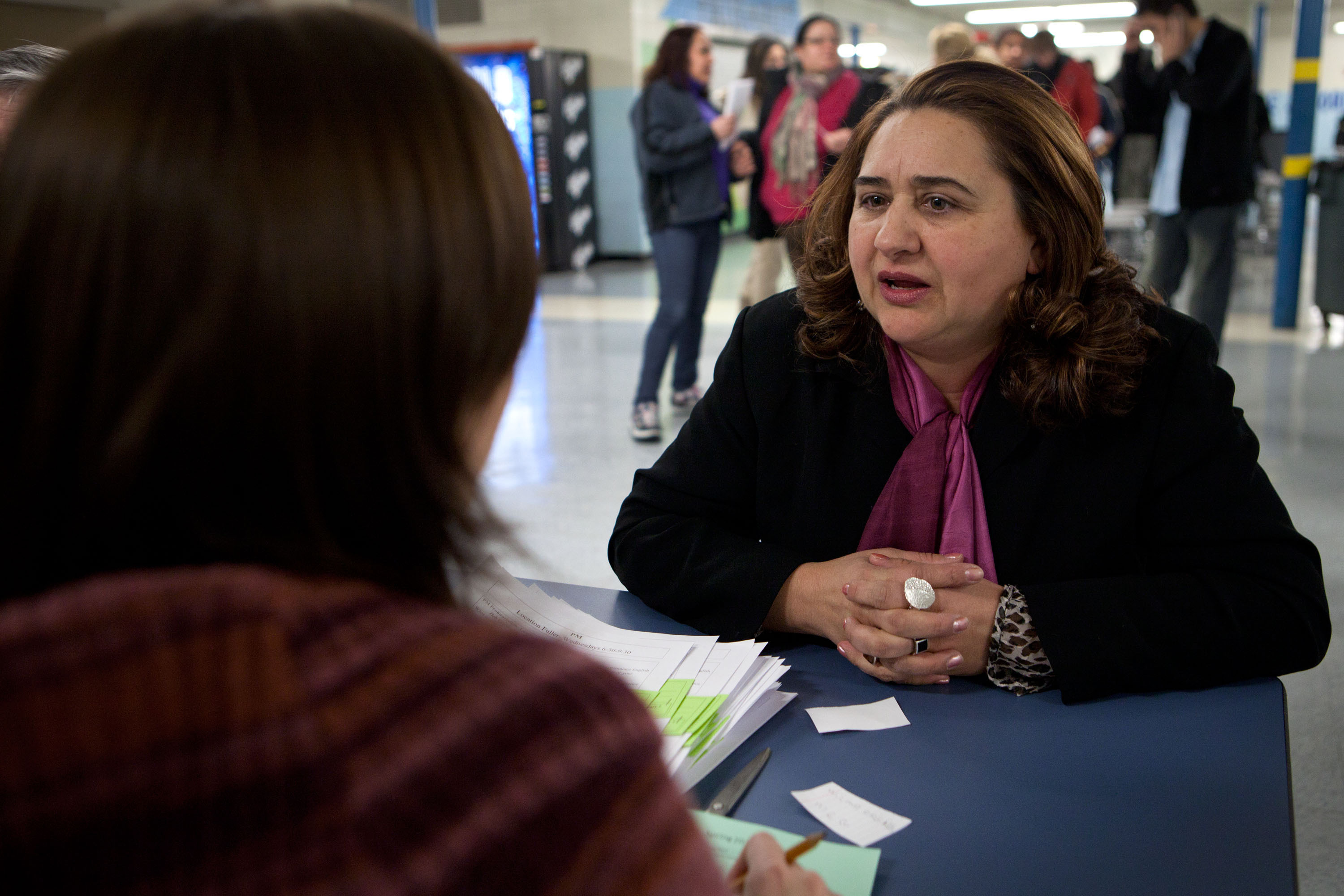 Framingham resident Maria Barbalho, right, and her husband are taking ESL classes after nearly 20 years in the tightknit Brazilian community.