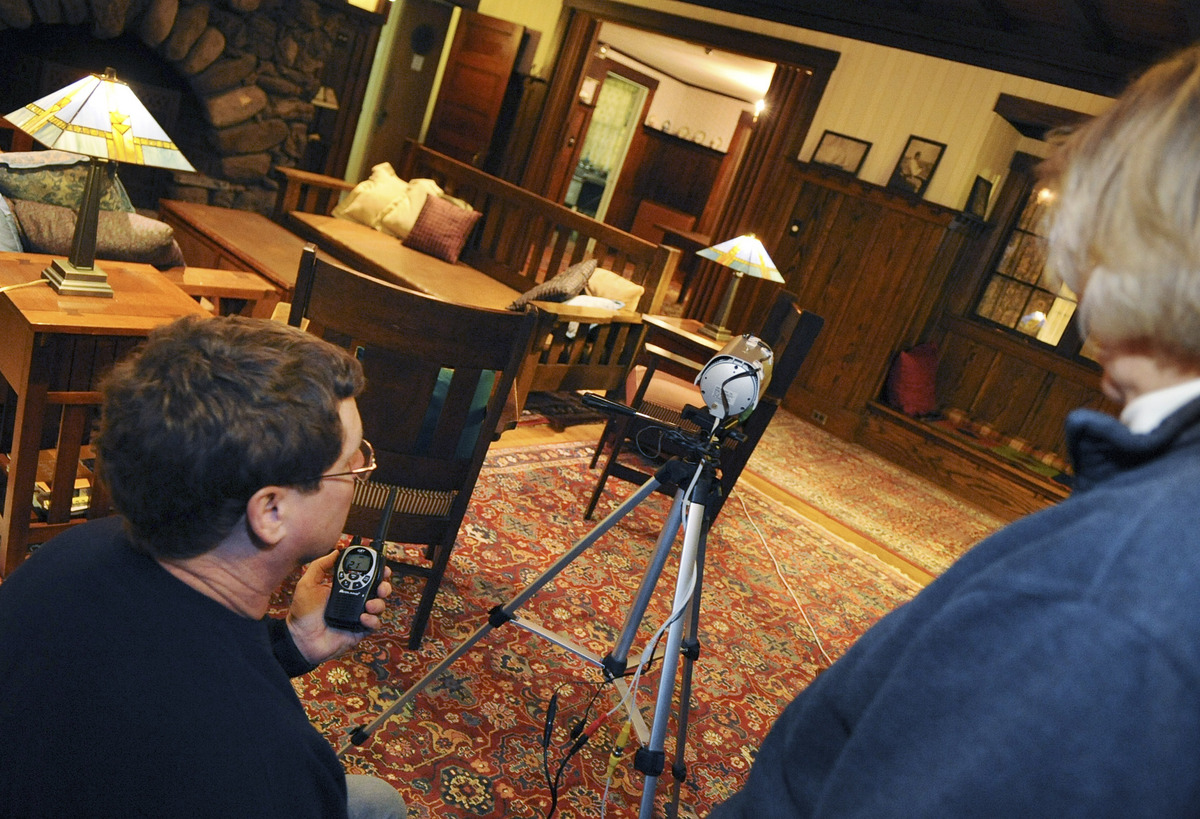 Paranormal investigators Jim Stonier and Susan Yeates set up an infrared camera in a building at Veasey Memorial Park.