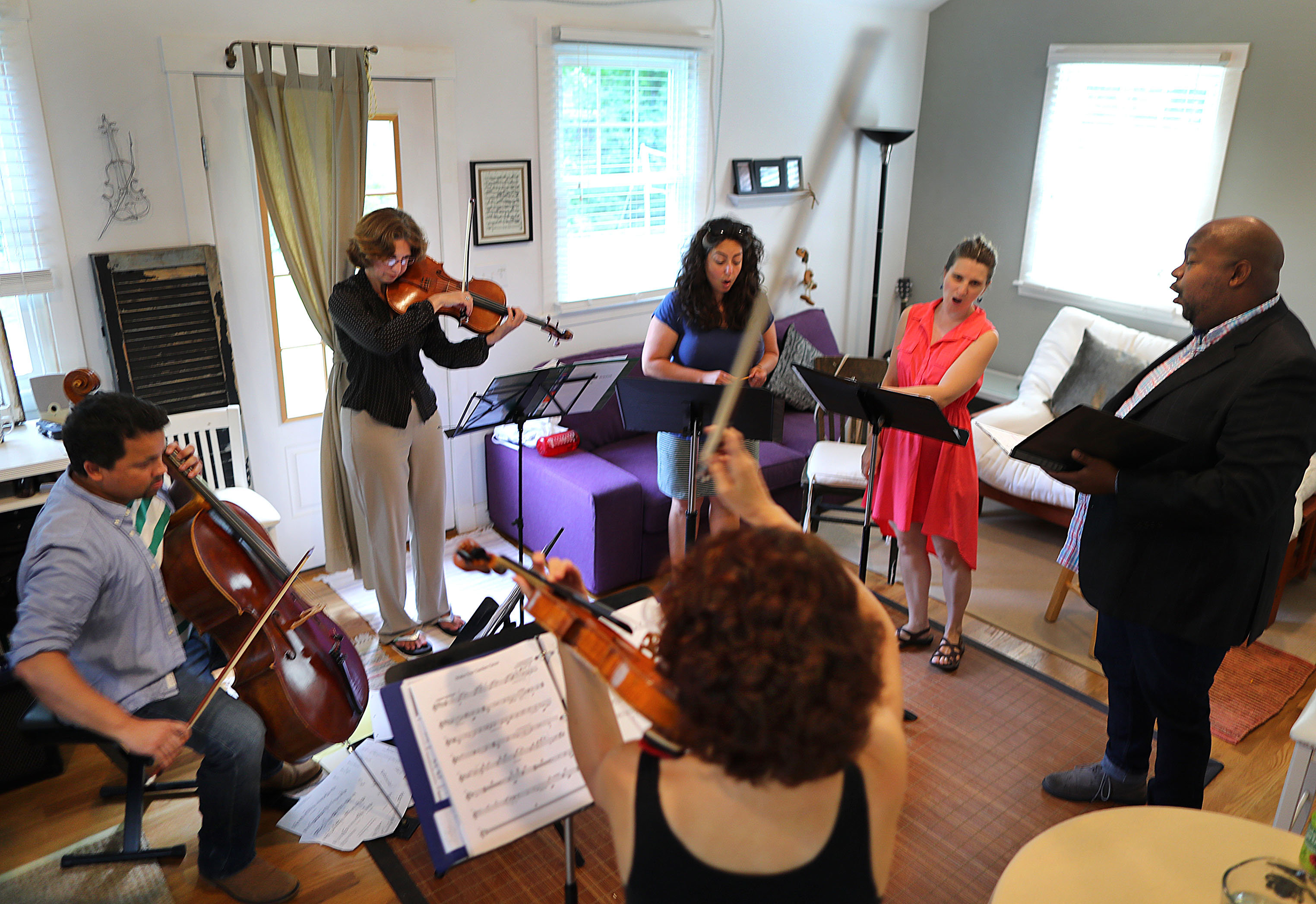 “What compels me is to take music where it’s needed and treat everyone with respect,” says Shelter Music Boston founder Julie Leven, a violinist (foreground), here with Shelter Music players rehearsing for a world premiere. Clockwise from left: Cellist Javiar Caballero, violinist Rebecca Strauss, and singers Carrie Cheron, Jessica Petrus, and Rashaun Campbell.