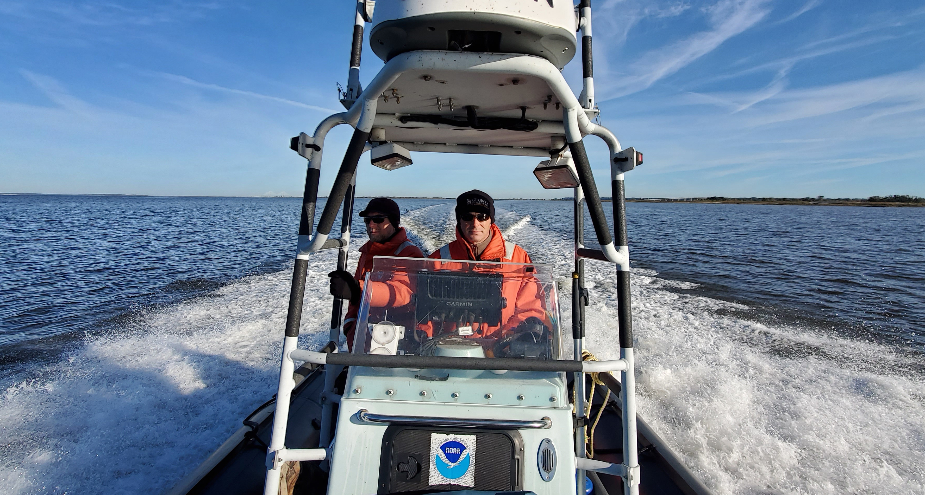 Clay George, left, and Trip Kolkmeyer, wildlife biologist with the Georgia Department of Natural Resources, aboard a NOAA Zodiac.
