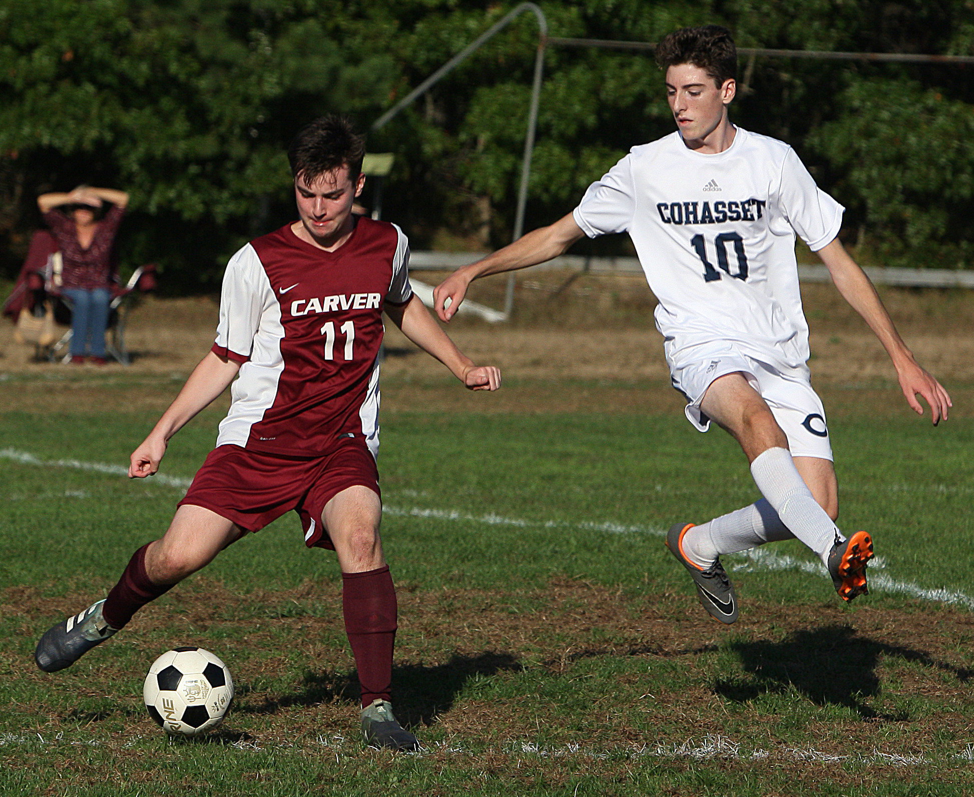 Carver sophomore Mike Sawicki keeps the ball away from Cohasset’s Jack Elliot.