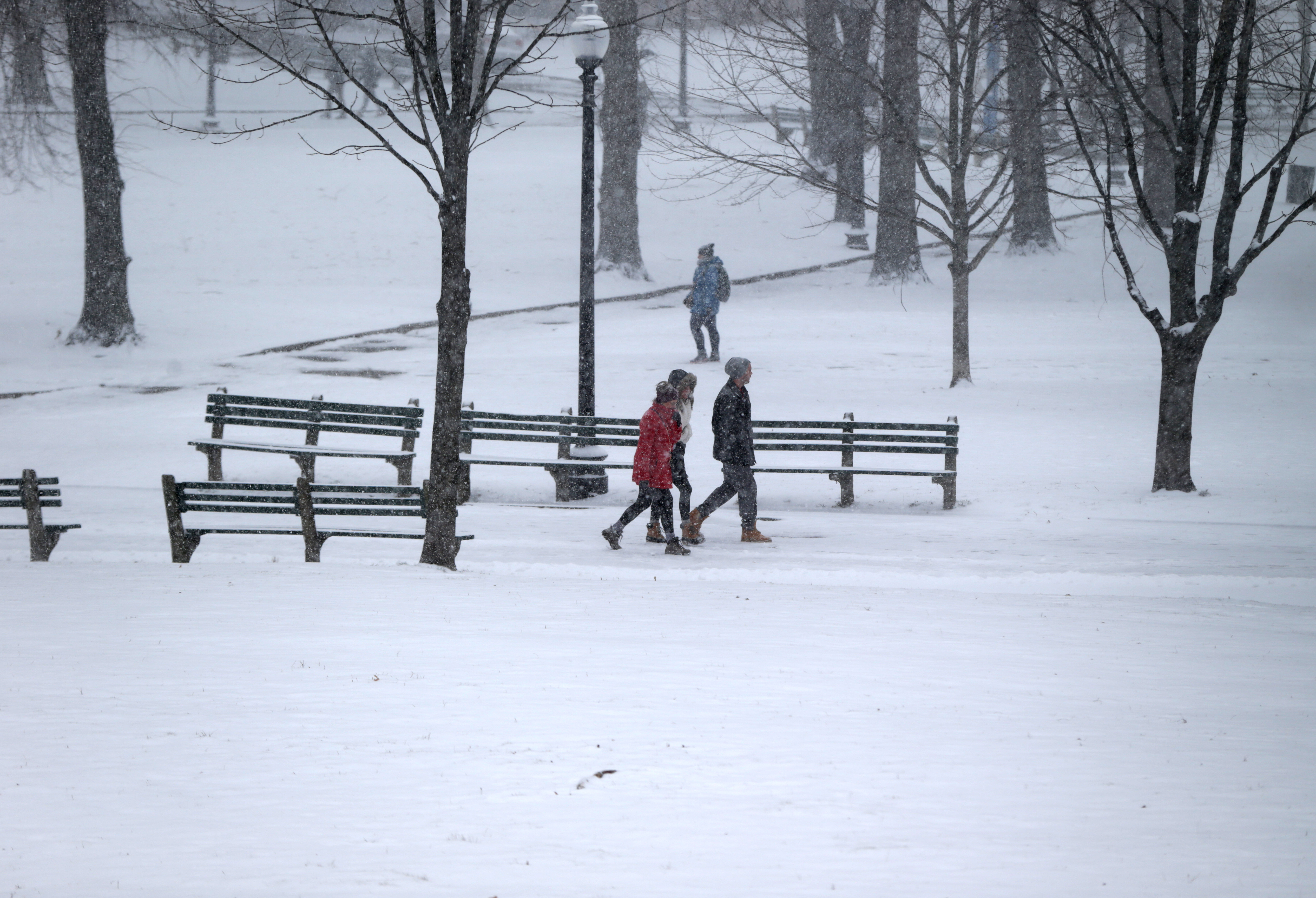 Pedestrians walked through Boston Common in the middle of the storm.