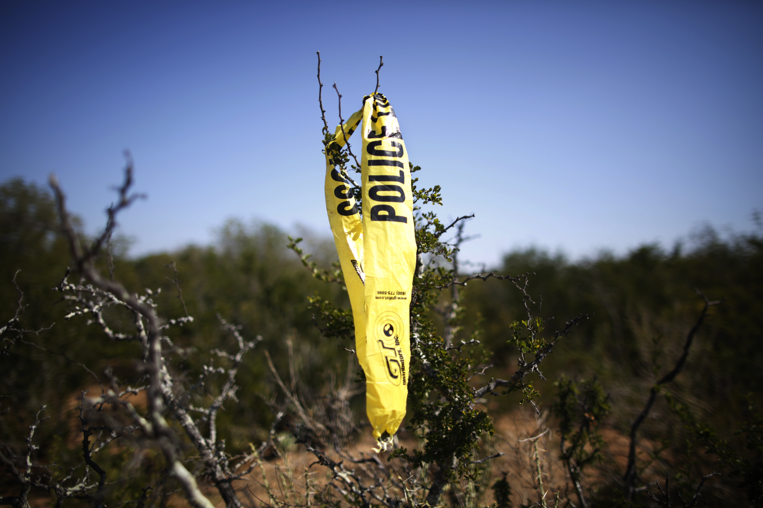 Police tape hung from the black brush where, two years earlier, a skull was found that was a “probable match”for Santos Interiano.