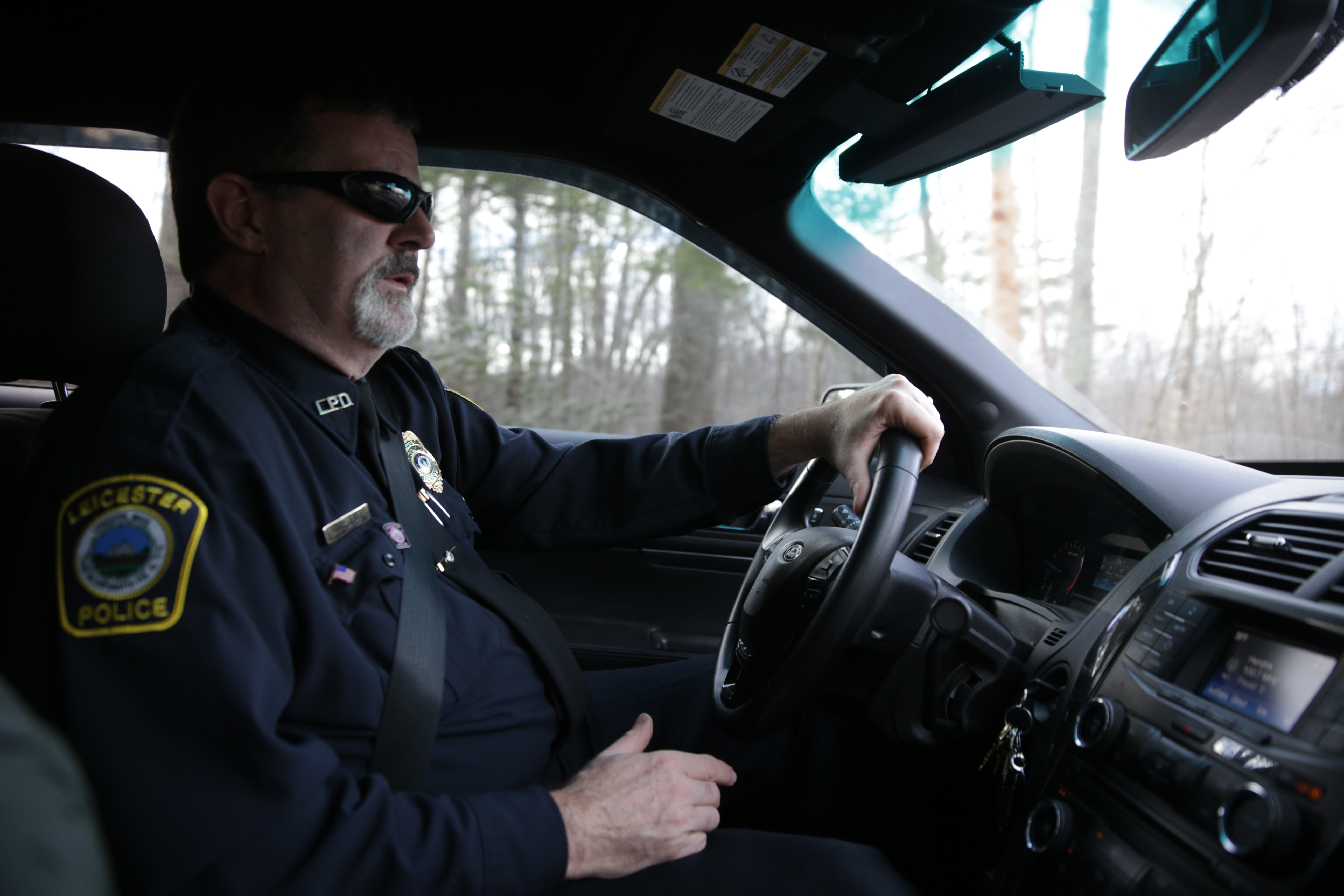 Leicester Police Chief Jim Hurley drives through the town in his cruiser.