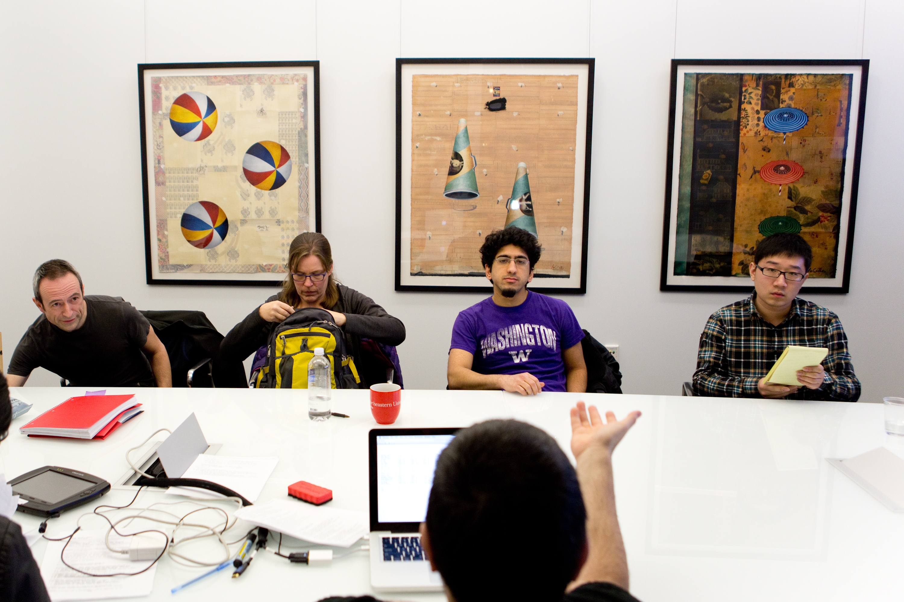 Students Steve Court, Doyle Ravnass, Bilal Khan, and Xiangyu Zheng spoke with grader Therapon Skotiaiotis in their computer science class at Northeastern’s Seattle campus.