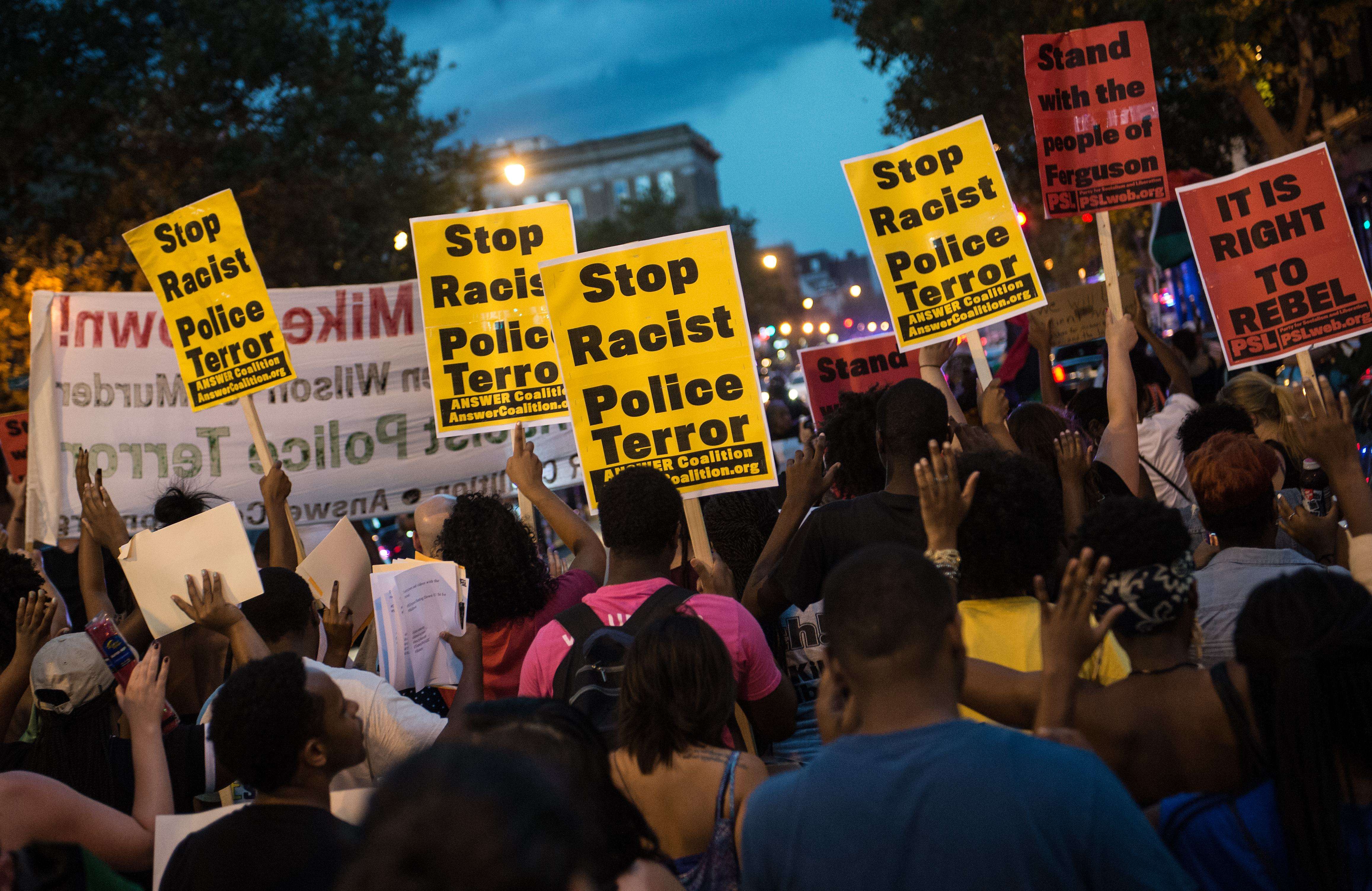 Marchers in Washington protested the killing of black teenager Michael Brown, who was shot by a white police officer in Ferguson, Mo.