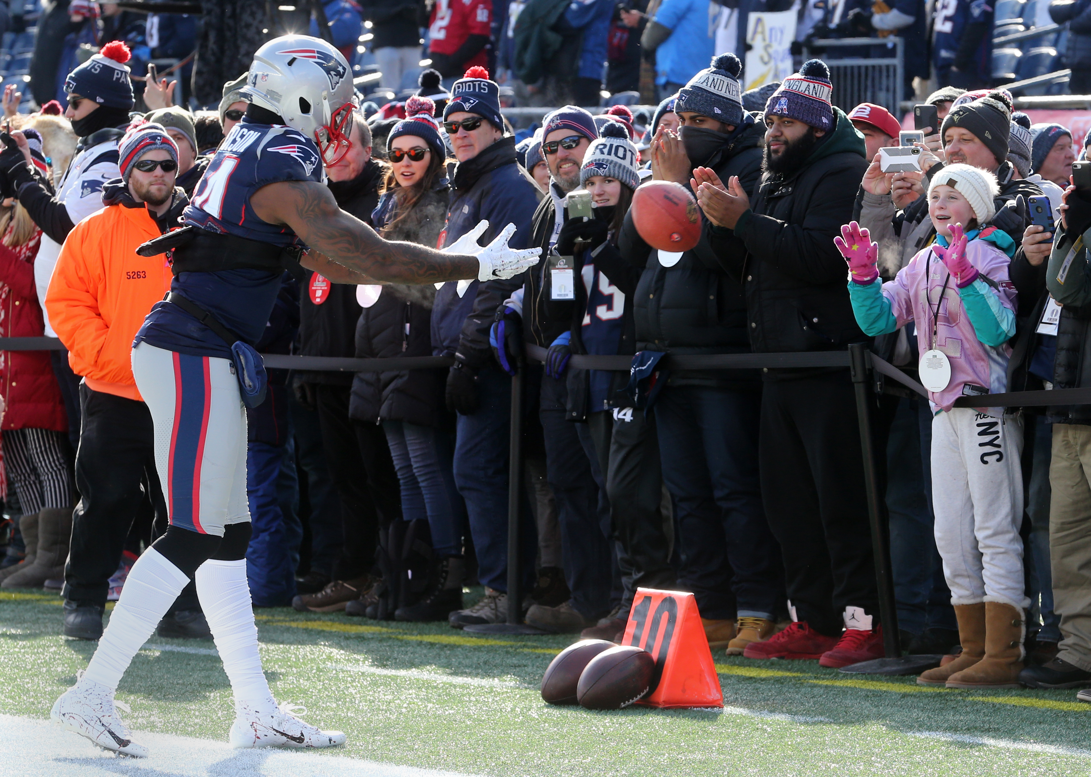 Cordarelle Patterson plays catch with the fans before the game.