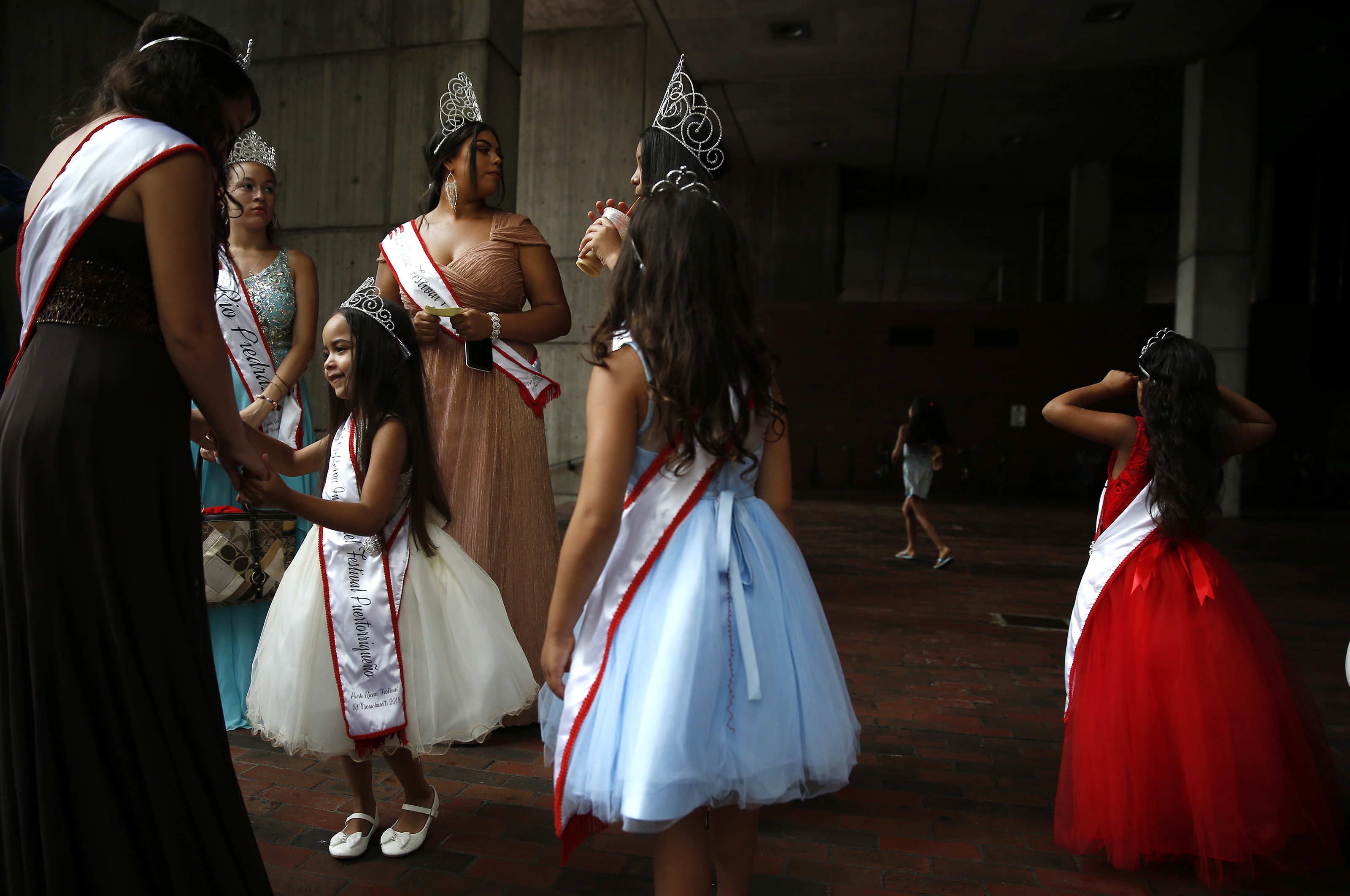 July 23, Boston I was covering a press conference at City Hall. City Hall is where photos go to die; it’s a notoriously ugly building, but there is this beautiful light that sometimes happens under this awning. When I came outside, I immediately saw these girls in tiaras. They were taking part in a flag-raising for the Puerto Rican Festival. I stopped and started taking pictures for a stand-alone feature. It was just a happy accident. The light was soft and hit them in this shadowless way. These girls in beautiful costumes were a great contrast to an ugly building.