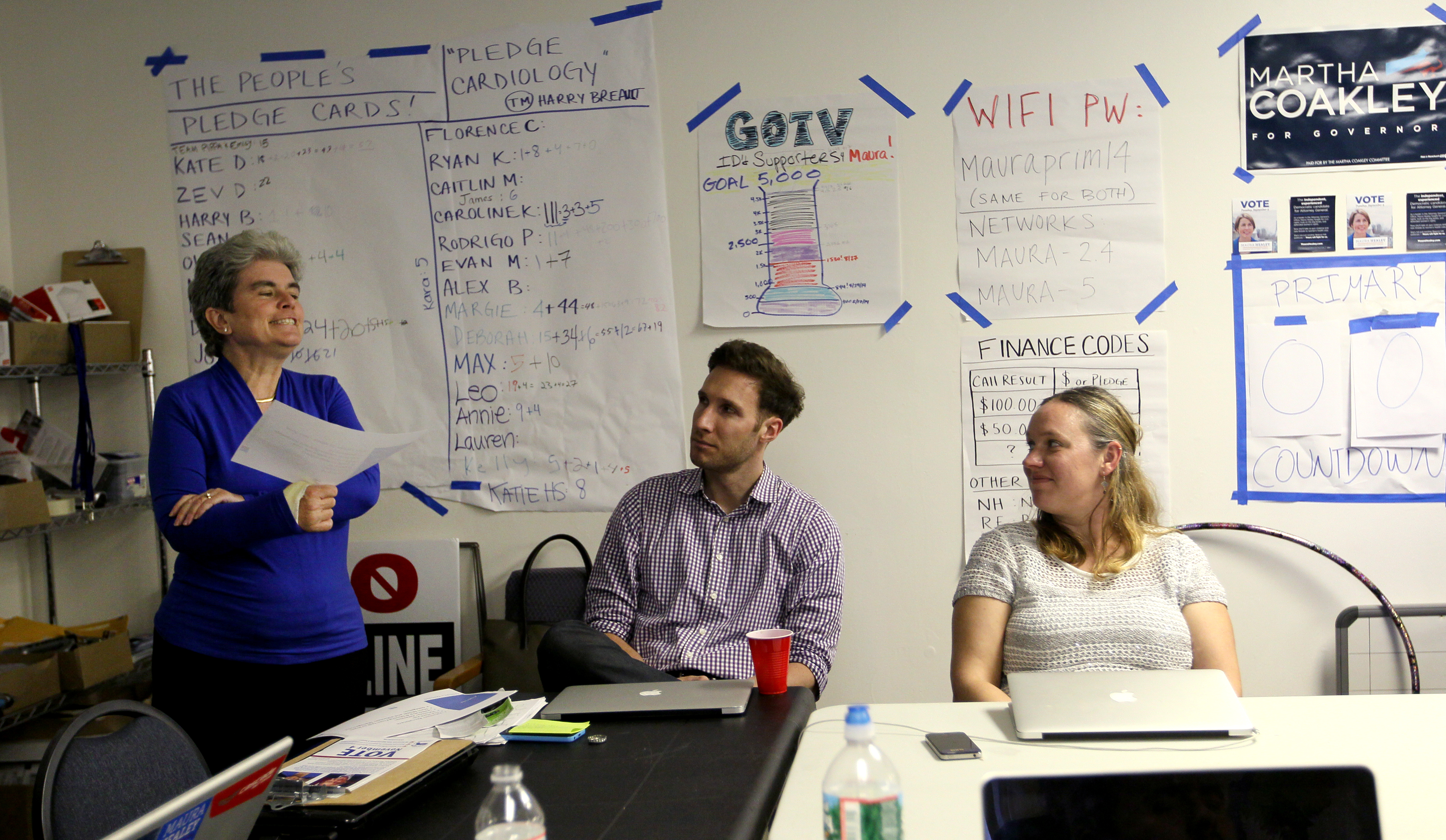 Canvasser Kate Donaghue led a training session for volunteers at attorney general hopeful Maura Healey’s Charlestown headquarters. Democratic candidates have signed the cast Donaghue wears for the wrist she broke while canvassing.