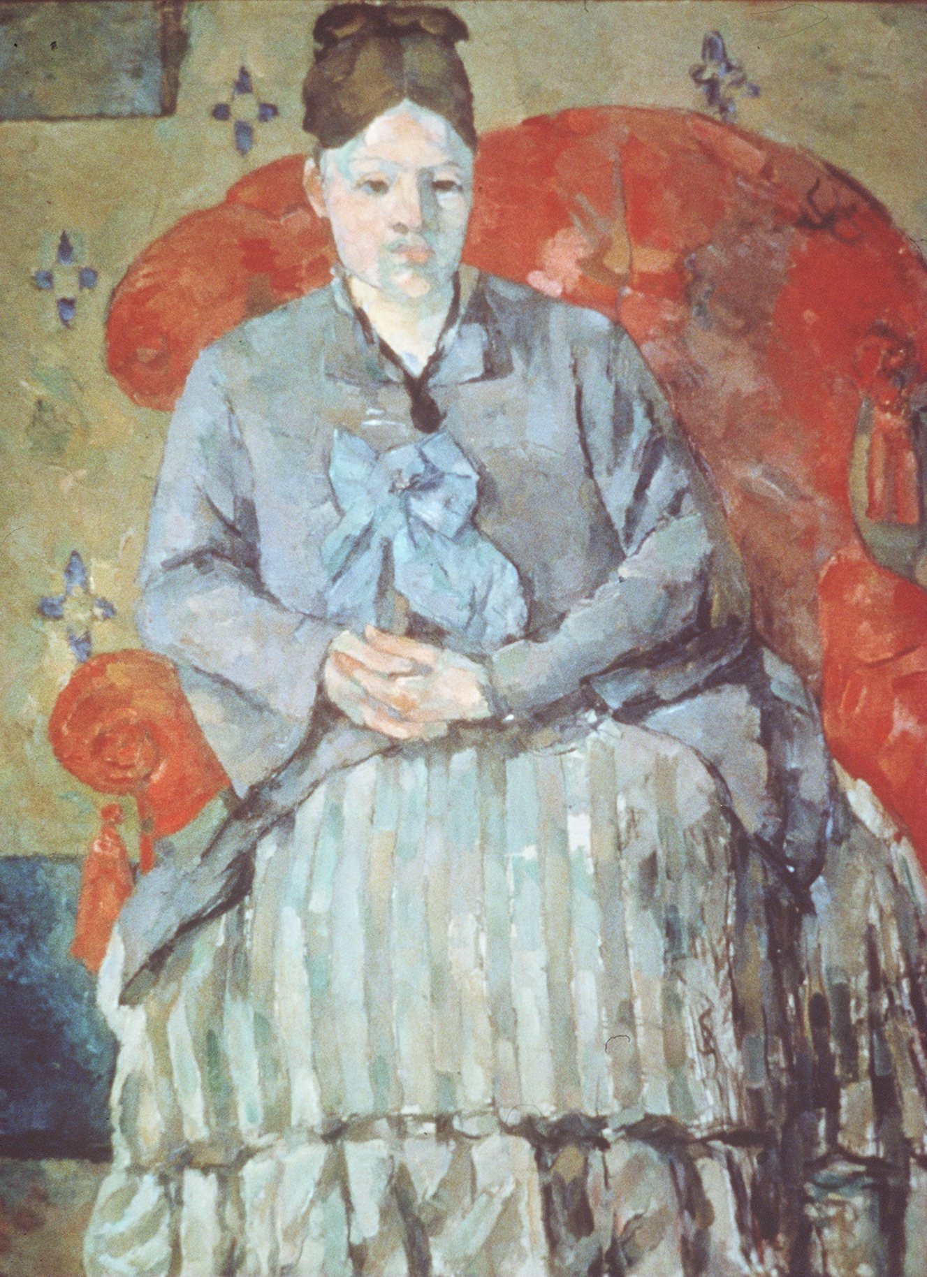 Alex Danchev’s insights into Cézanne’s life include the assertion that the artist’s wife (above in “Madame Cézanne in a Red Armchair”) has been unfairly maligned by other biographers.
