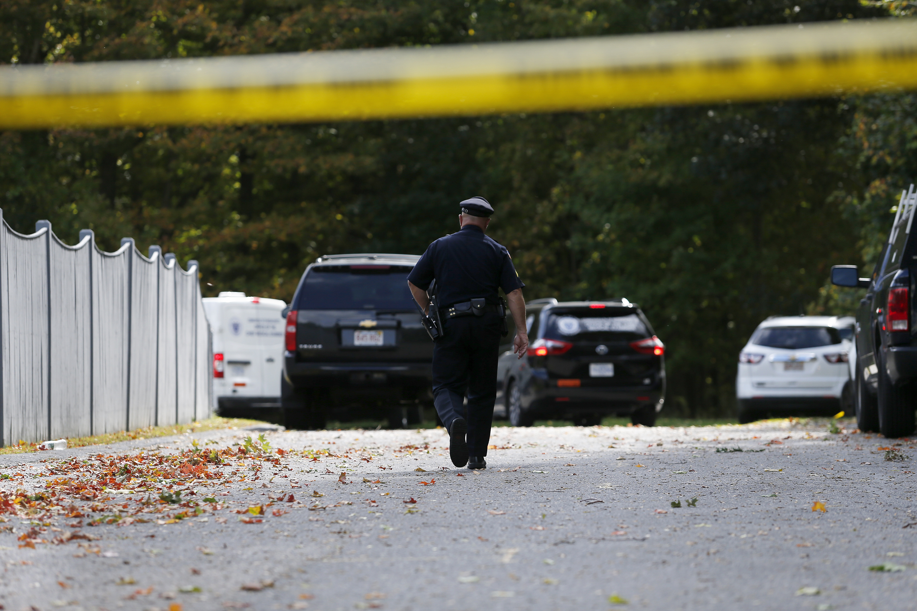 An officer walked towards Medical Examiners office vans as they entered the scene.