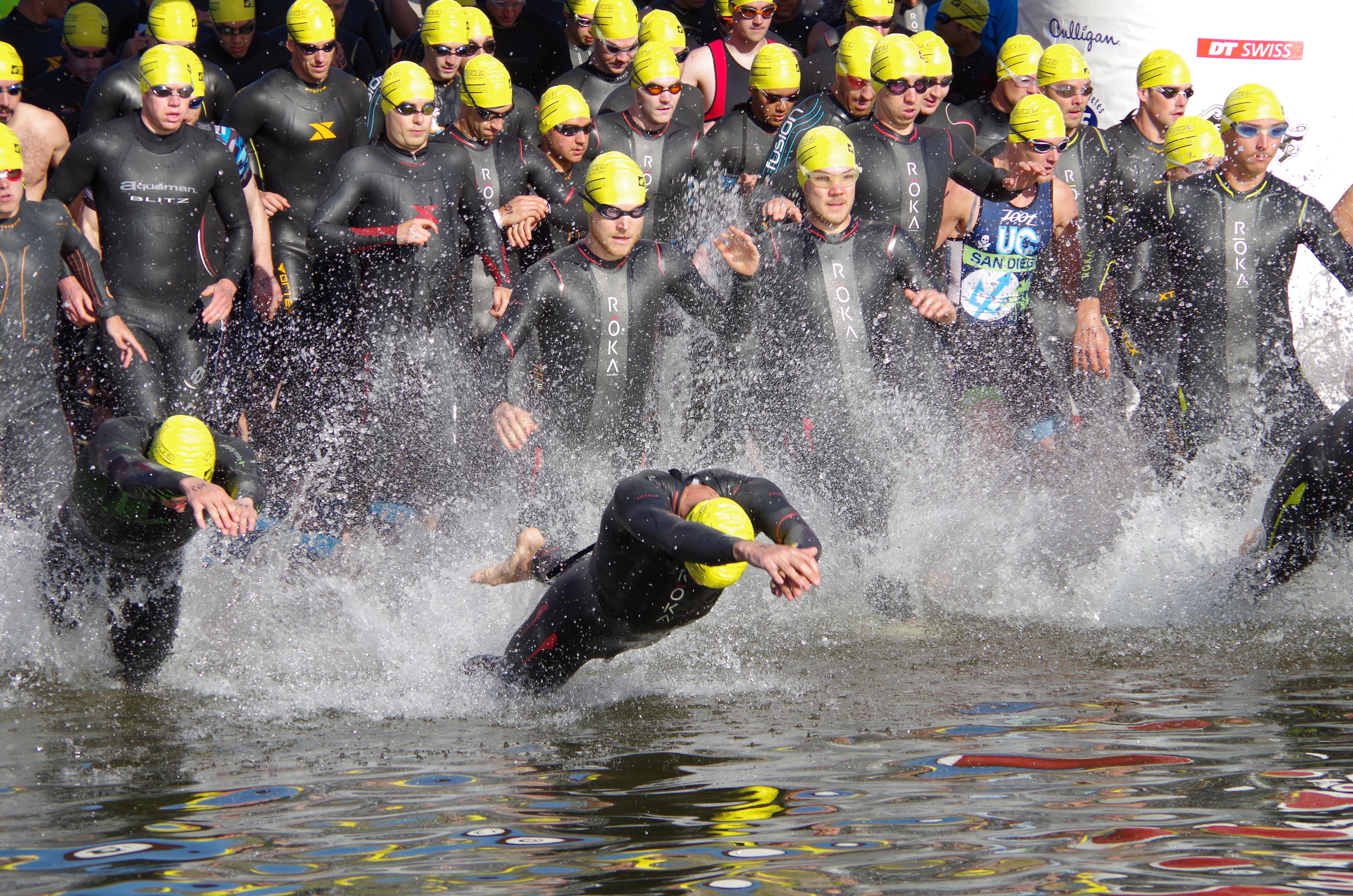 Swimmers in the men’s half-iron division take off at the start of the Wildflower triathlon.