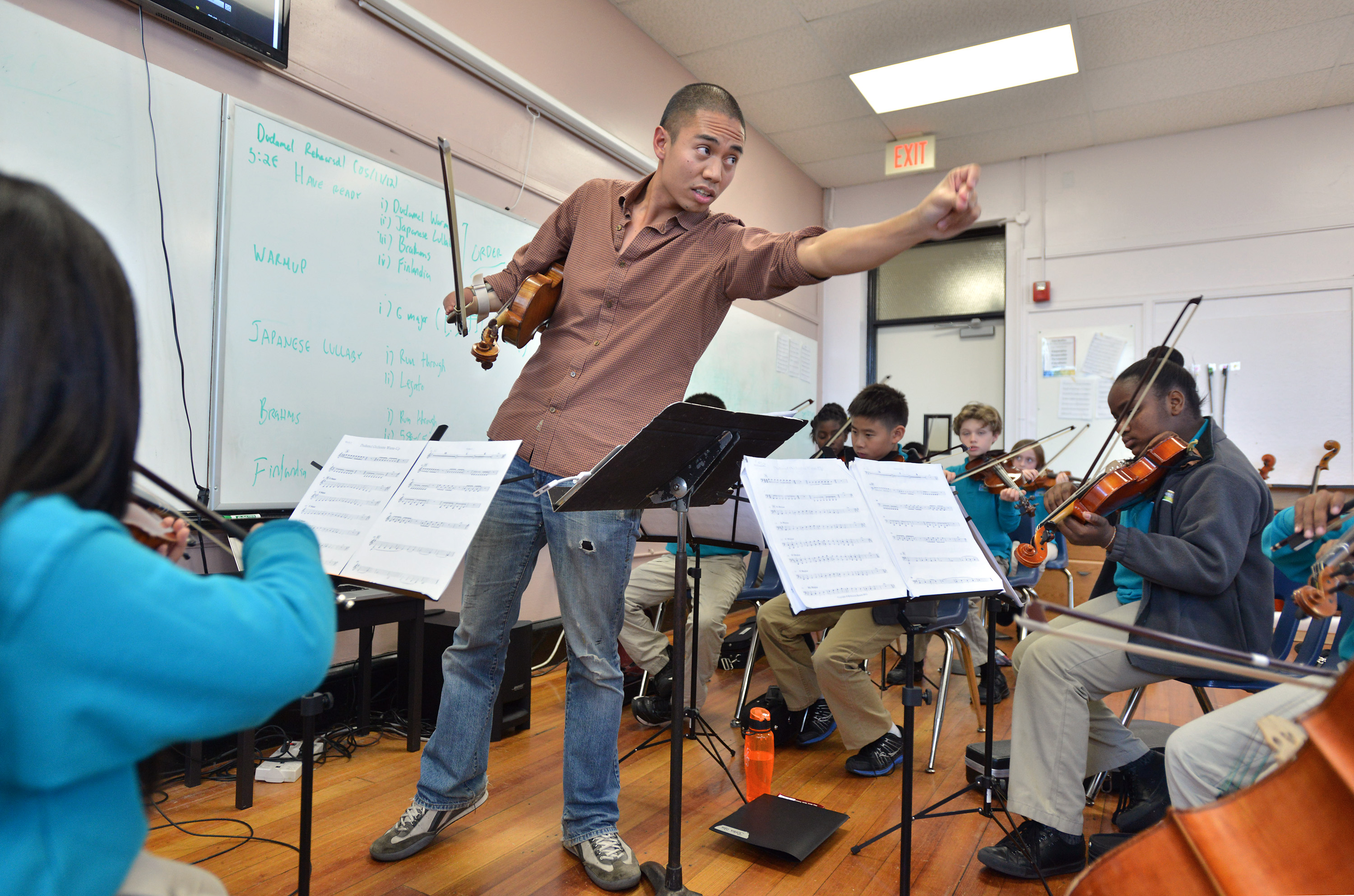 Adrian Anantawan, working with Conservatory Lab Charter School’s young musicians, moved his left arm to mark the rhythm instead of using a baton.