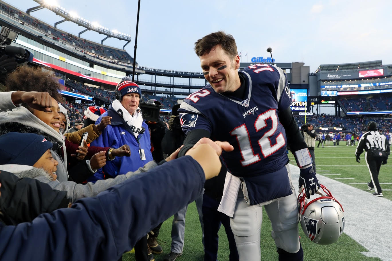 Tom Brady greets kids who were flown on the Patriots private jet to attend the Patriots-Bills game on Saturday.