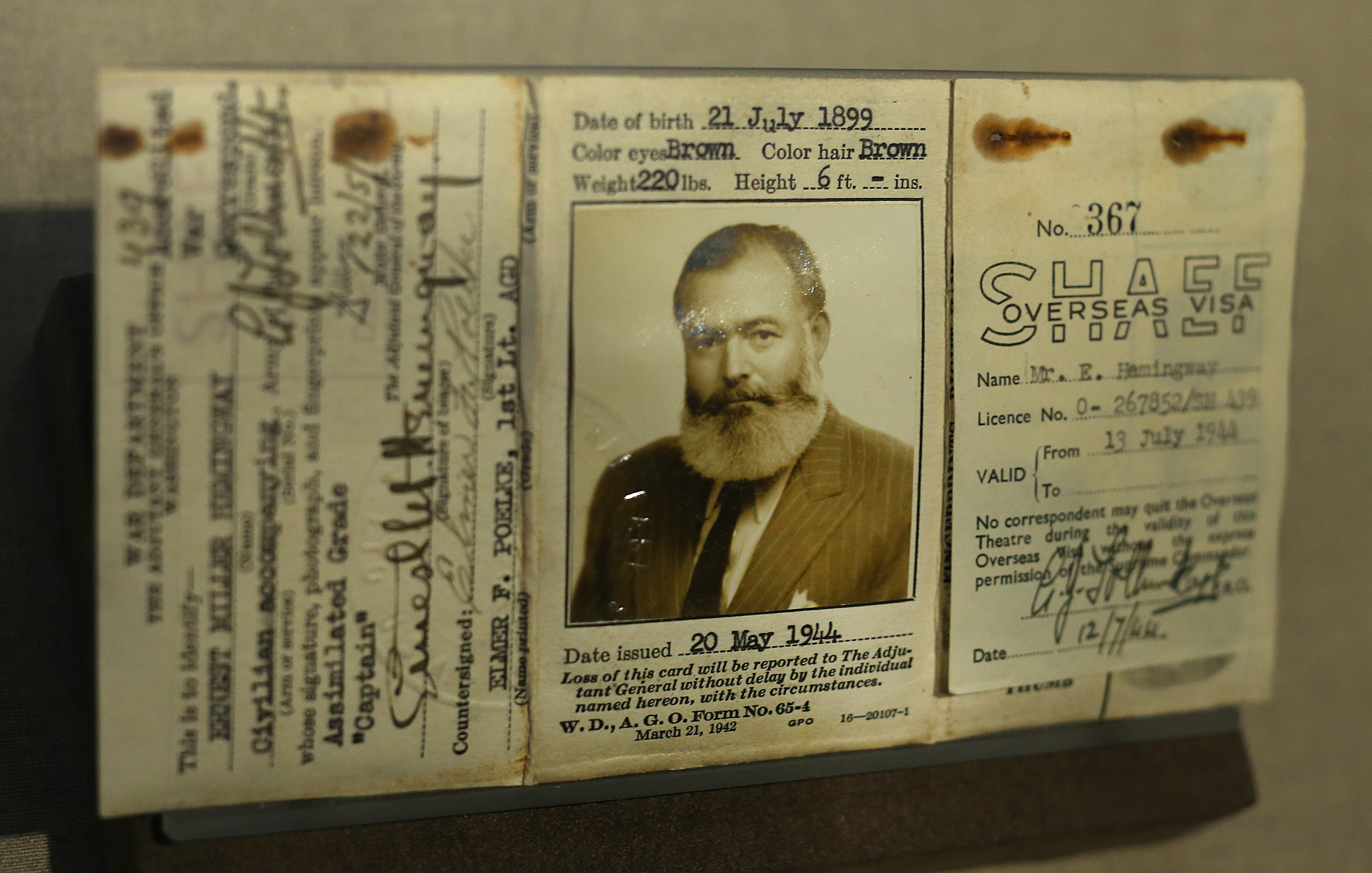 Hemingway’s visa (top), issued for his job as a World War II European correspondent for Collier’s magazine.