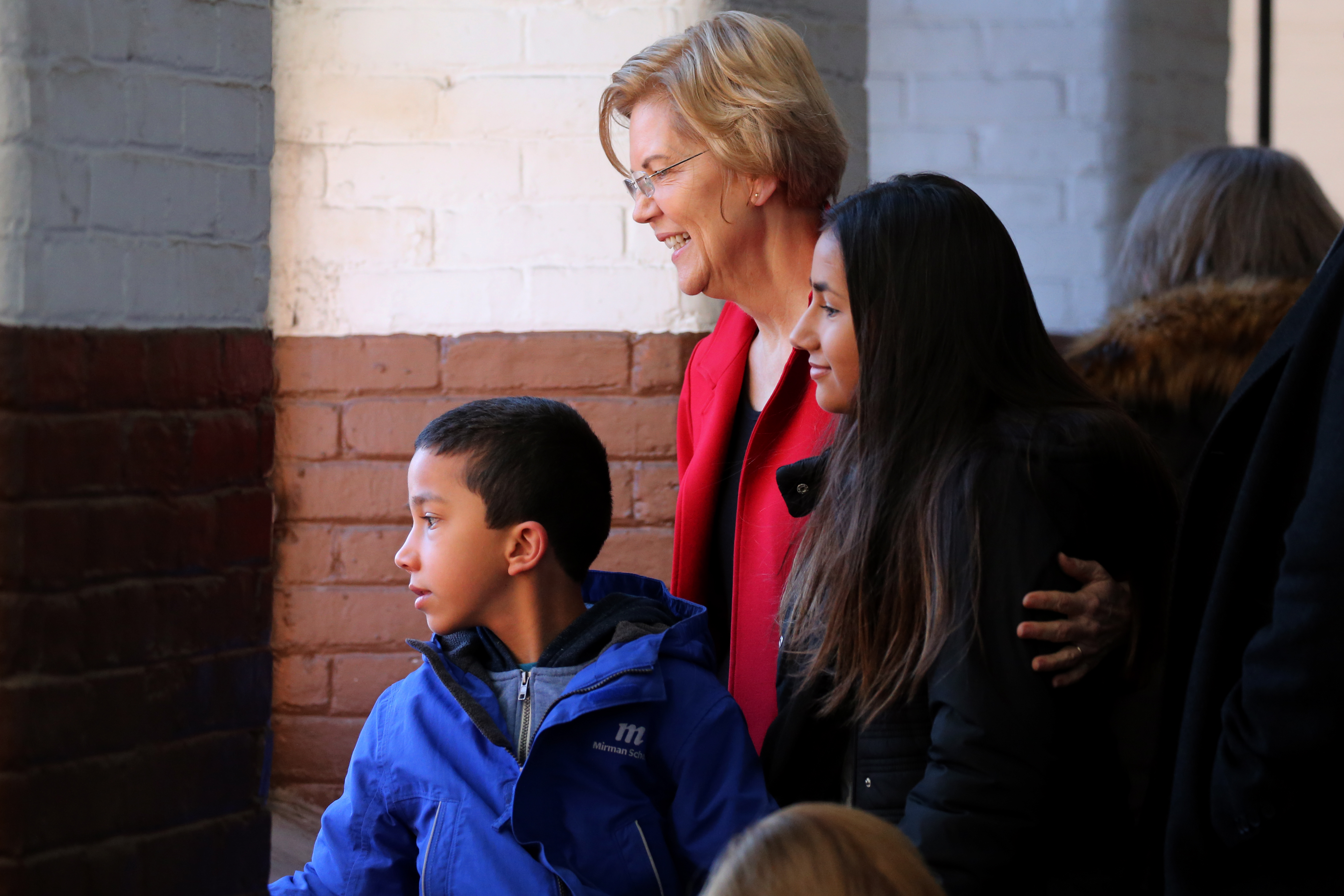 Warren looked at the crowd with her grandchildren, Atticus and Lavinia Tyagi.