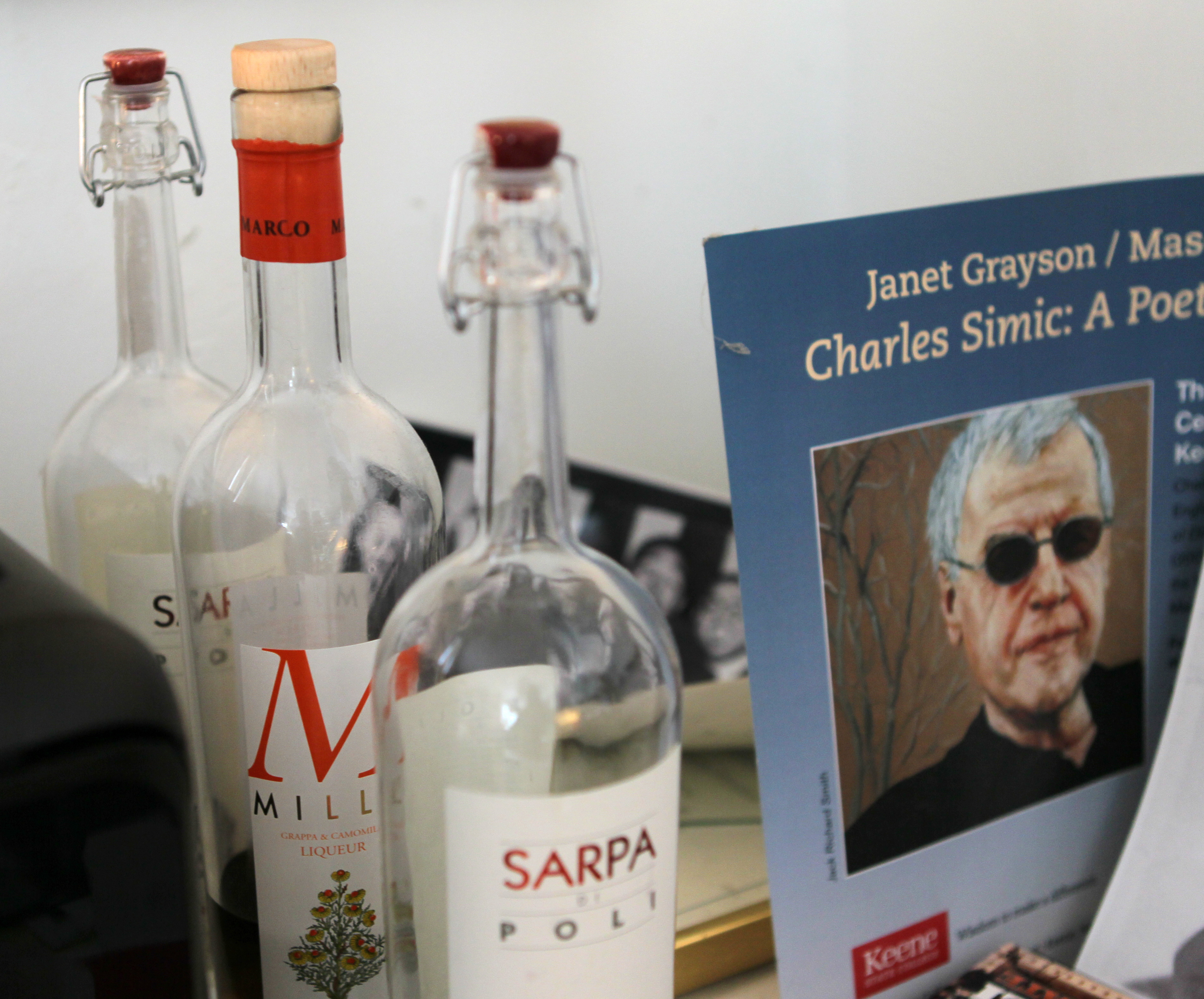 A photo of his father arm wrestling and a few bottles of grapa can be found in his office.