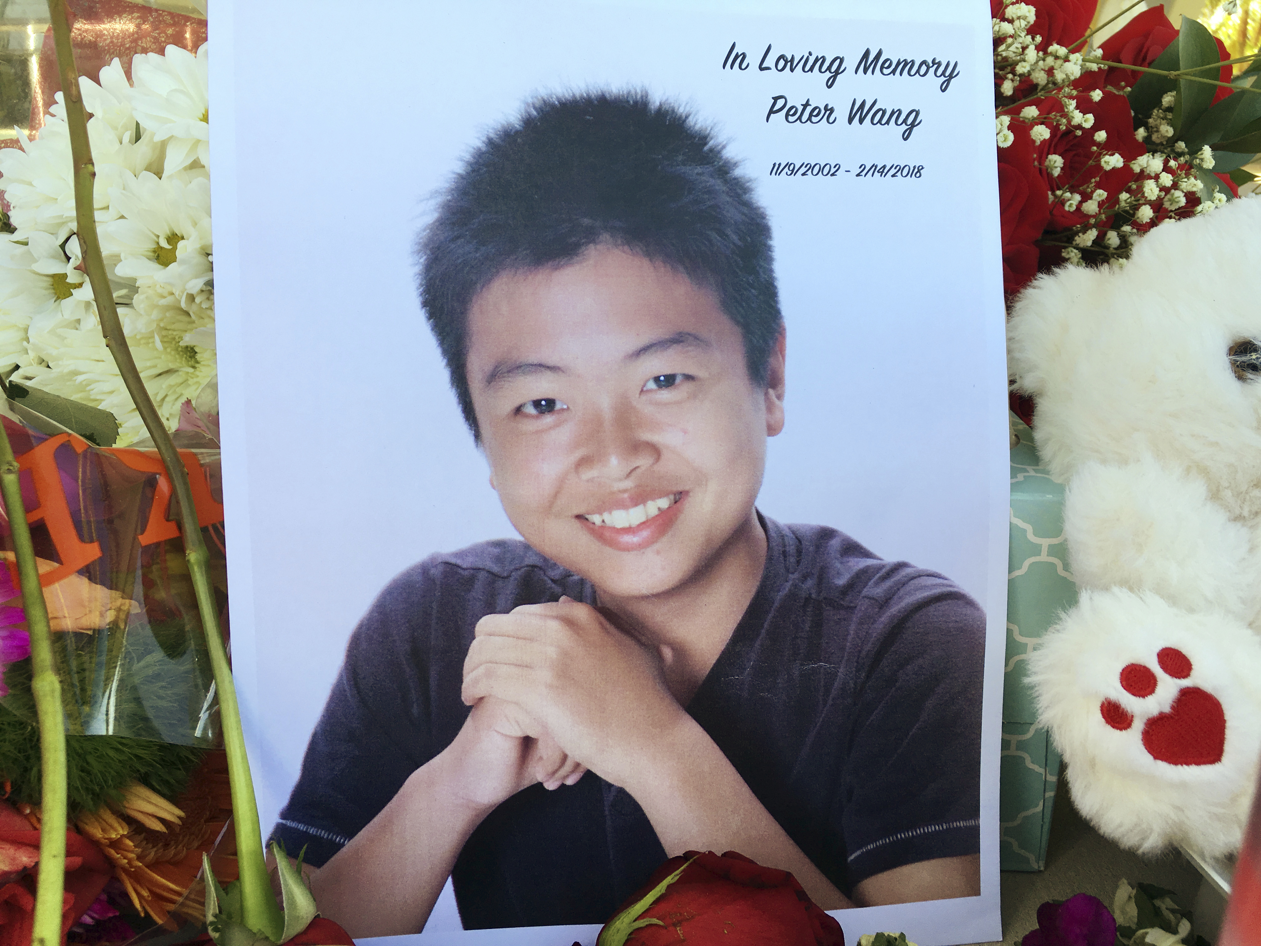 A photo of Peter Wang seen near a memorial in Parkland, Fla.