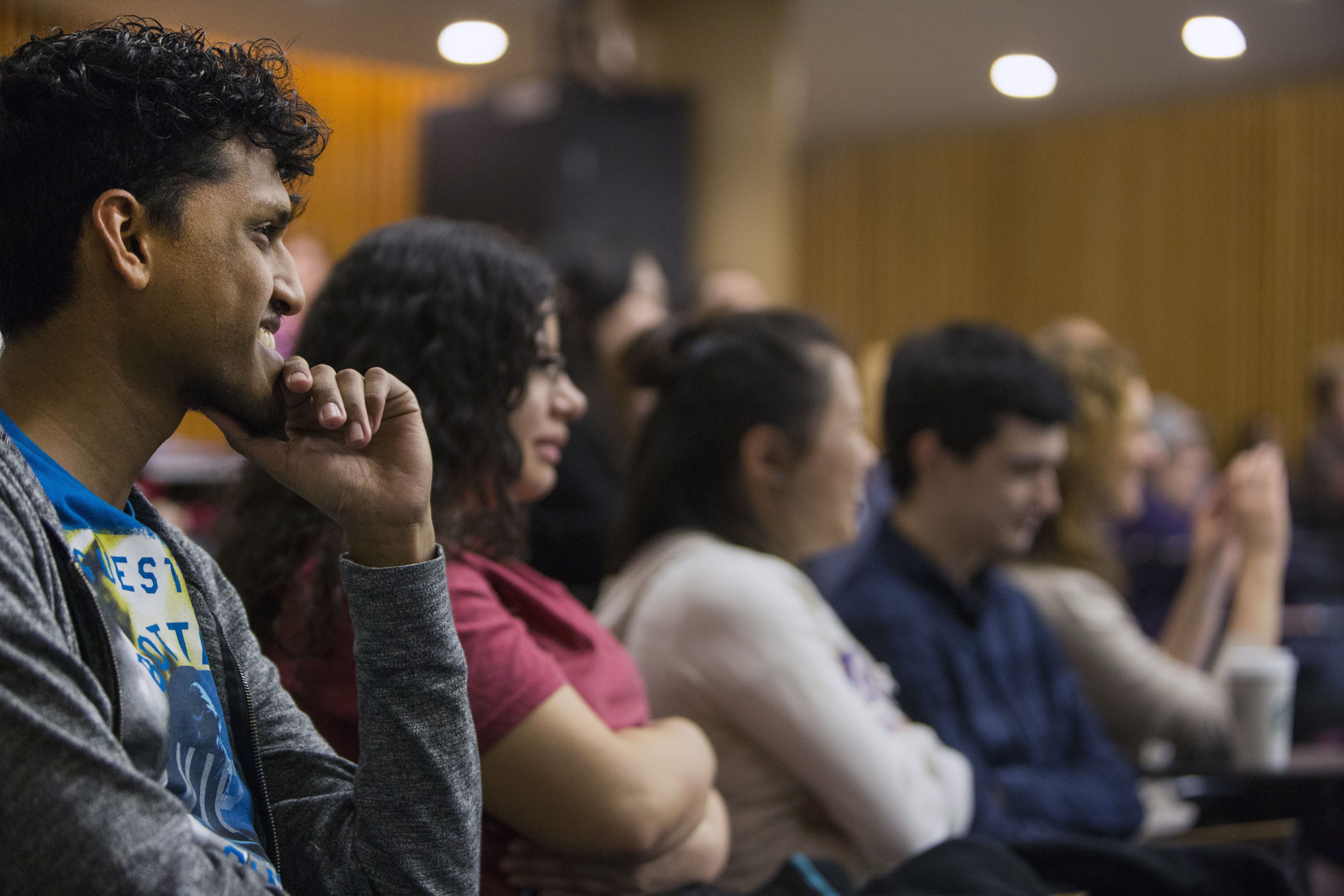 UMass Lowell student Rakesh Buchan (left) listens to one of the speakers.