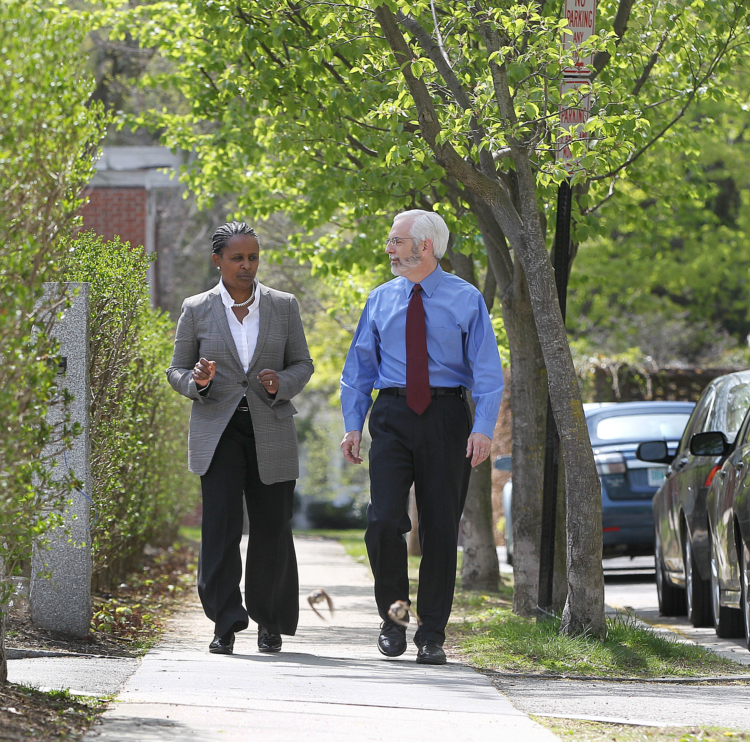 With step counter on his belt, Dreyfus holds a walking meeting with his general counsel, Stephanie Lovell, in Brookline.