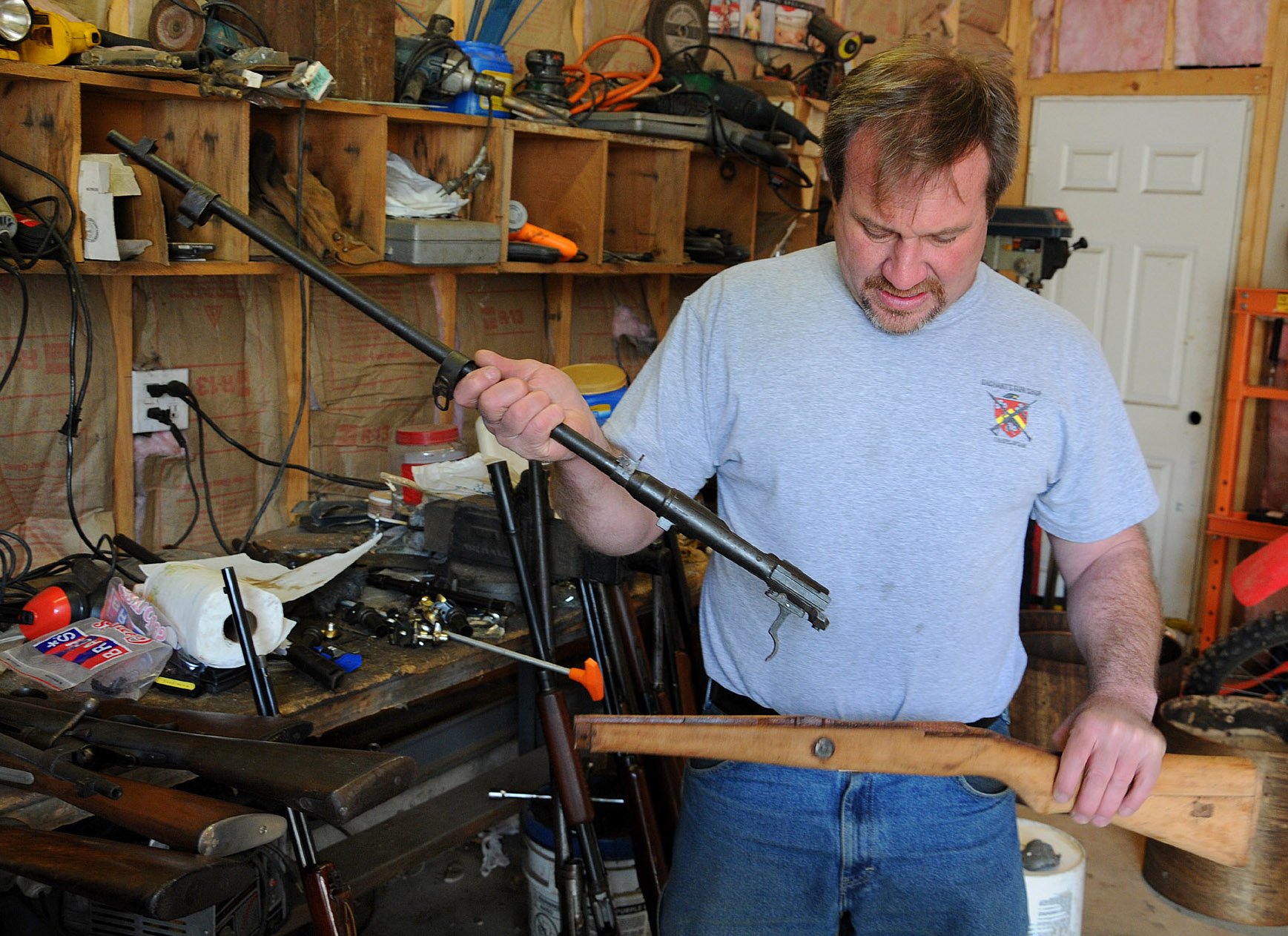 Bill Bachant works on a Japanese rifle at his shop in Lakeville. Items beyond repair, he says, he sells for parts.