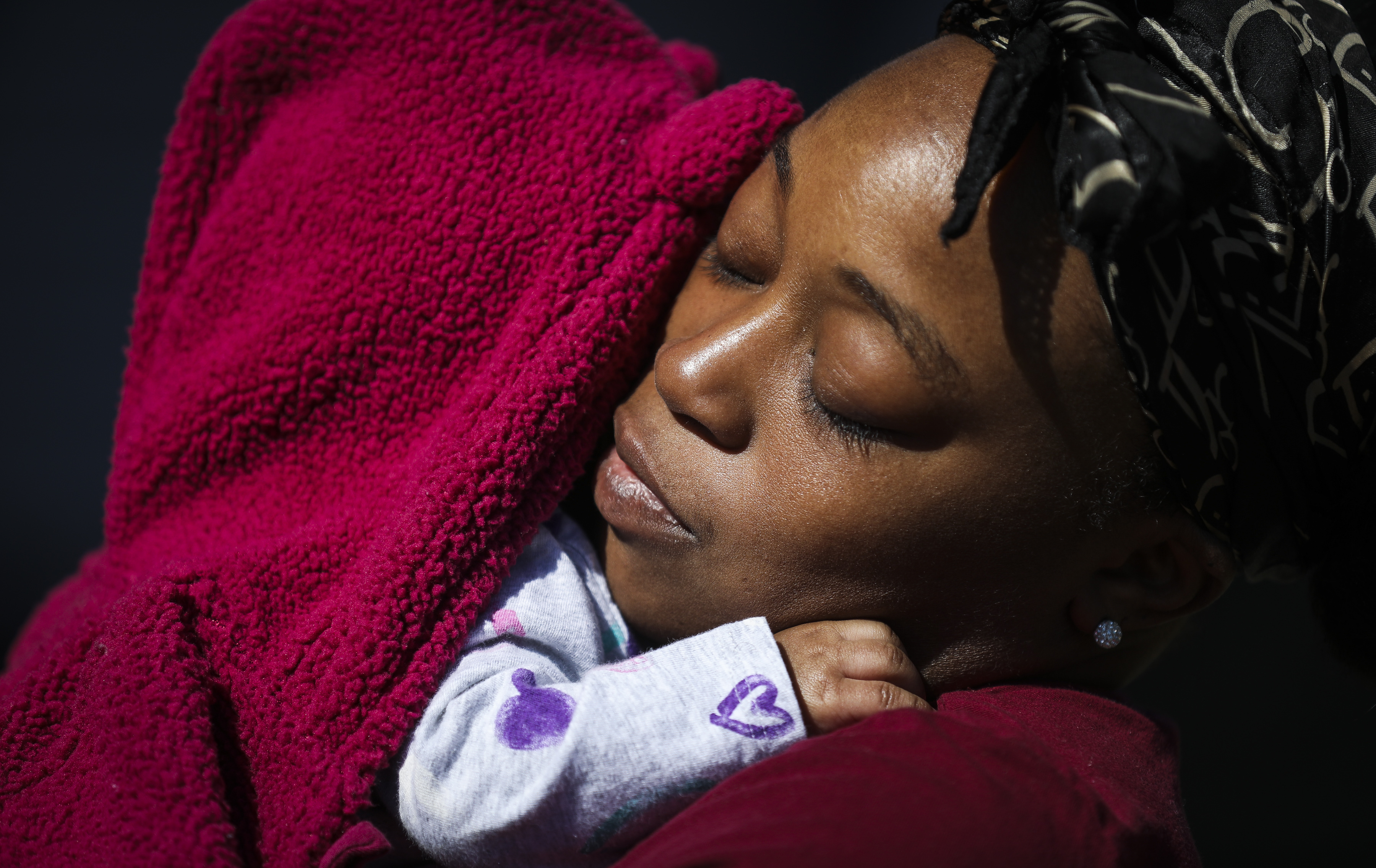 Karla Kiser comforted her daughter while spending some time in the sun at Medford Family Life Education Center.