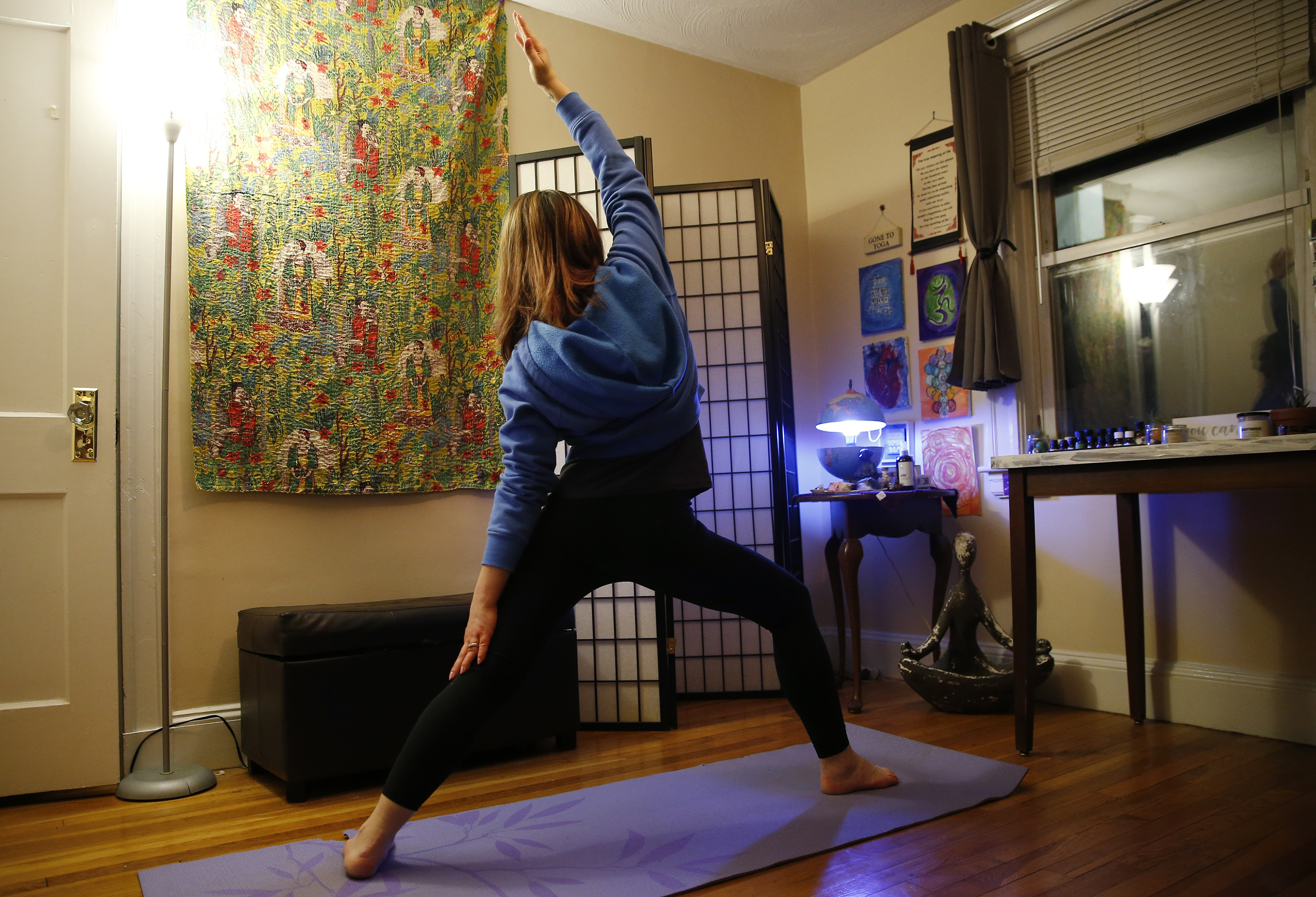 The woman has regained her strength and now practices yoga at home as part of her recovery.