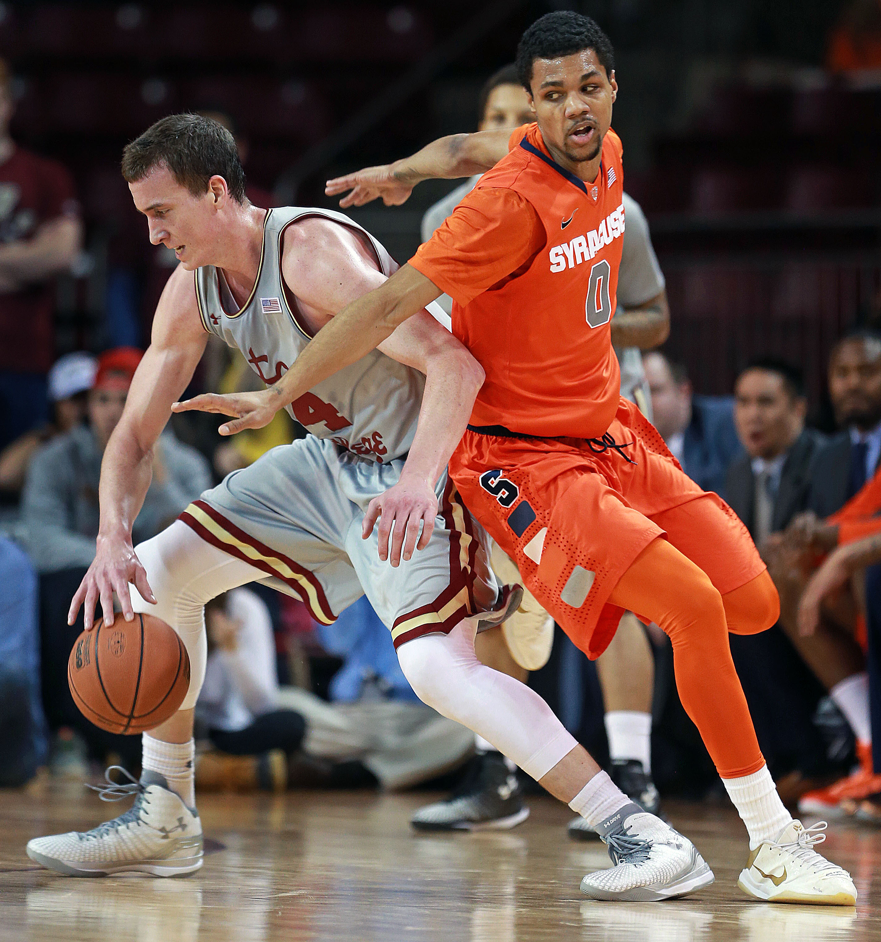 Syracuse’s Michael Gbinije (right) plays some tight defense on BC's Dennis Clifford.