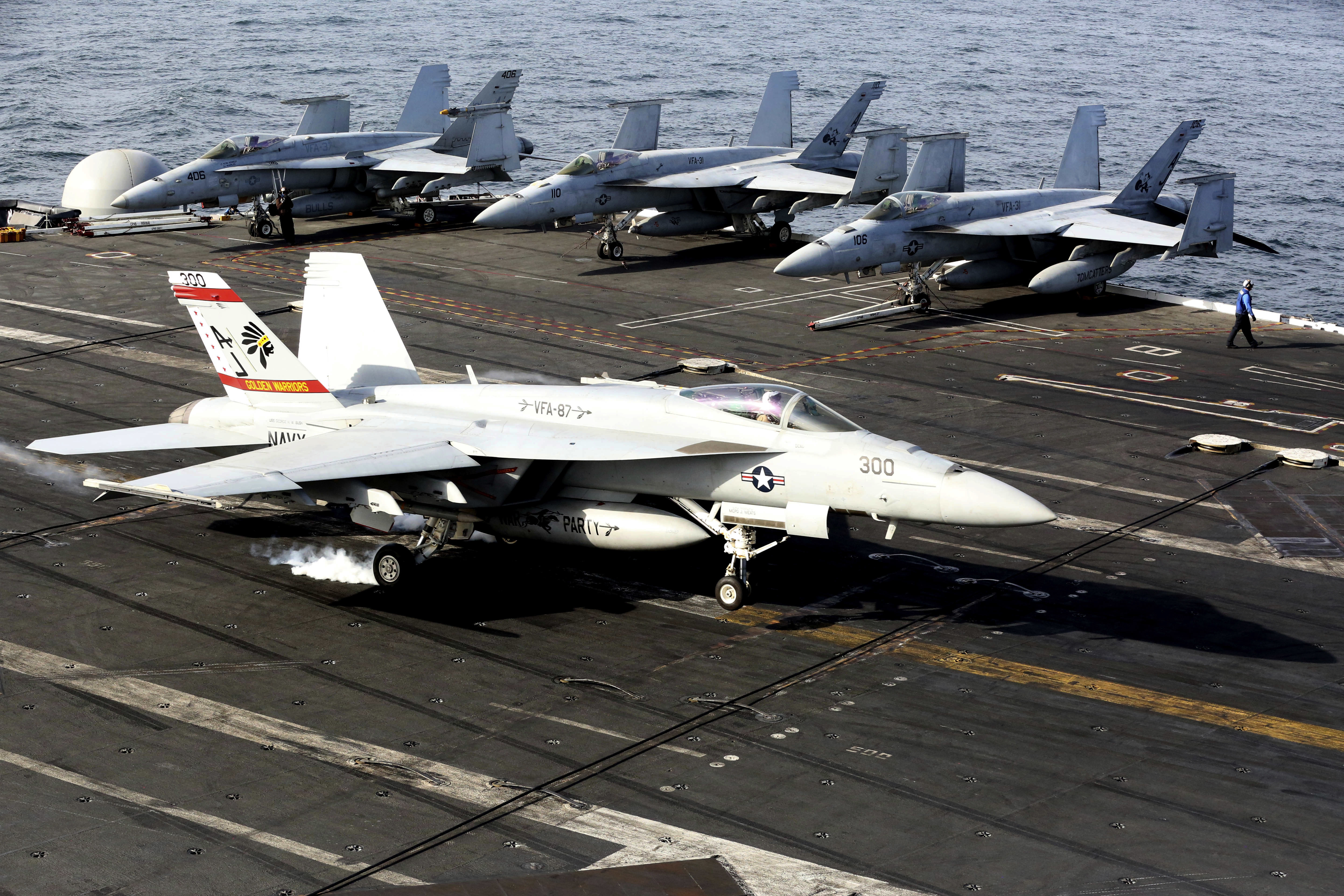 An F-18 fighter lands on the USS George H.W. Bush as it travels toward the Strait of Hormuz, on March 20, 2017.
