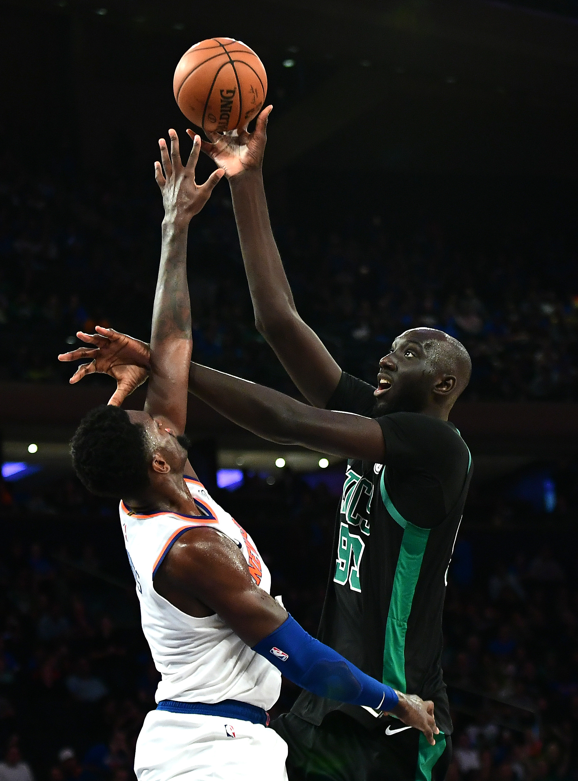 The Knicks’ Bobby Portis attempts to guard 7-foot-5 center Tacko Fall, who made his regular-season debut with the Celtics, thrilling fans at Madison Square Garden in New York.