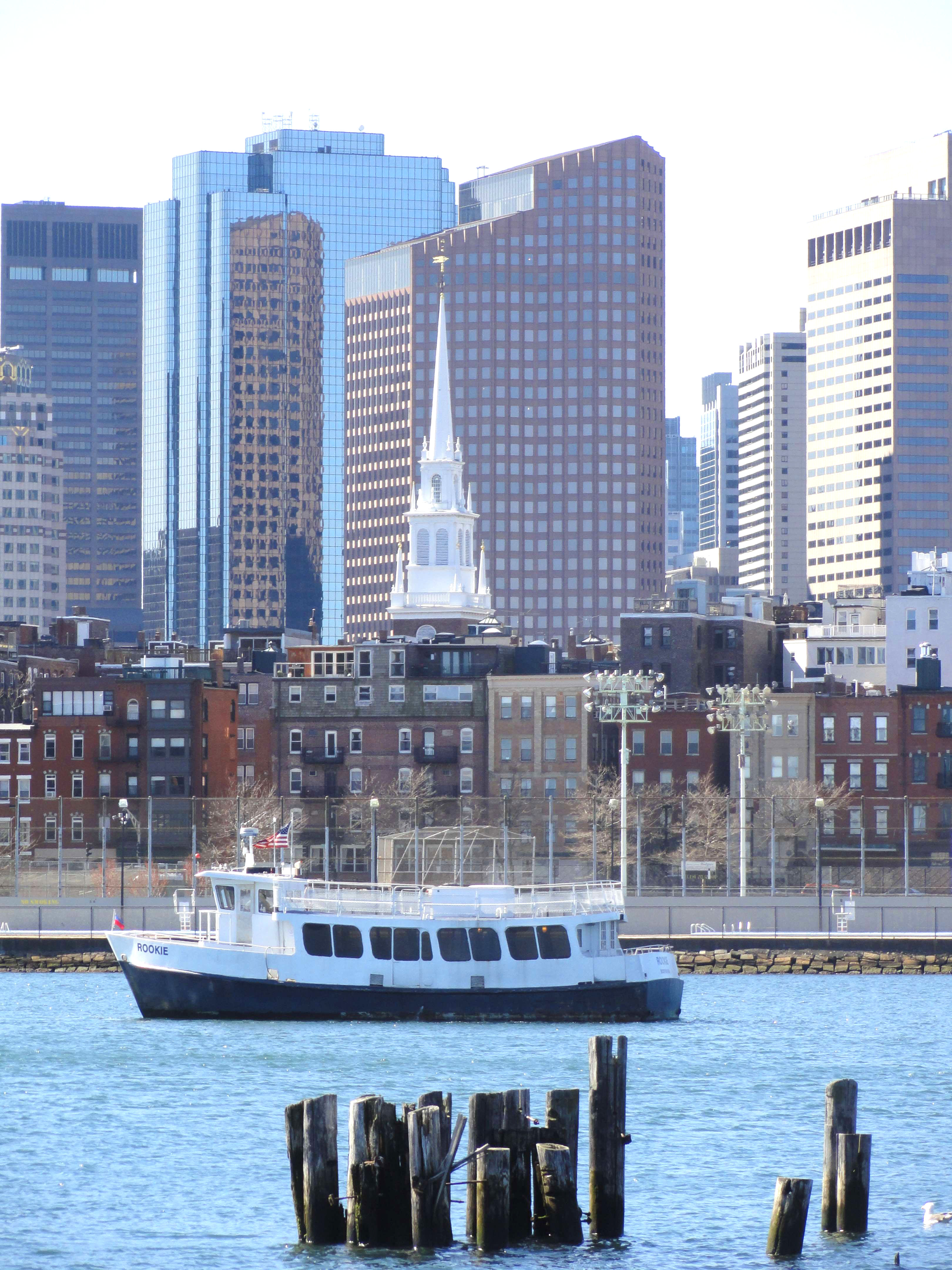 In Boston Harbor, the Charlestown MBTA ferry motors past the landmark Old North Church.