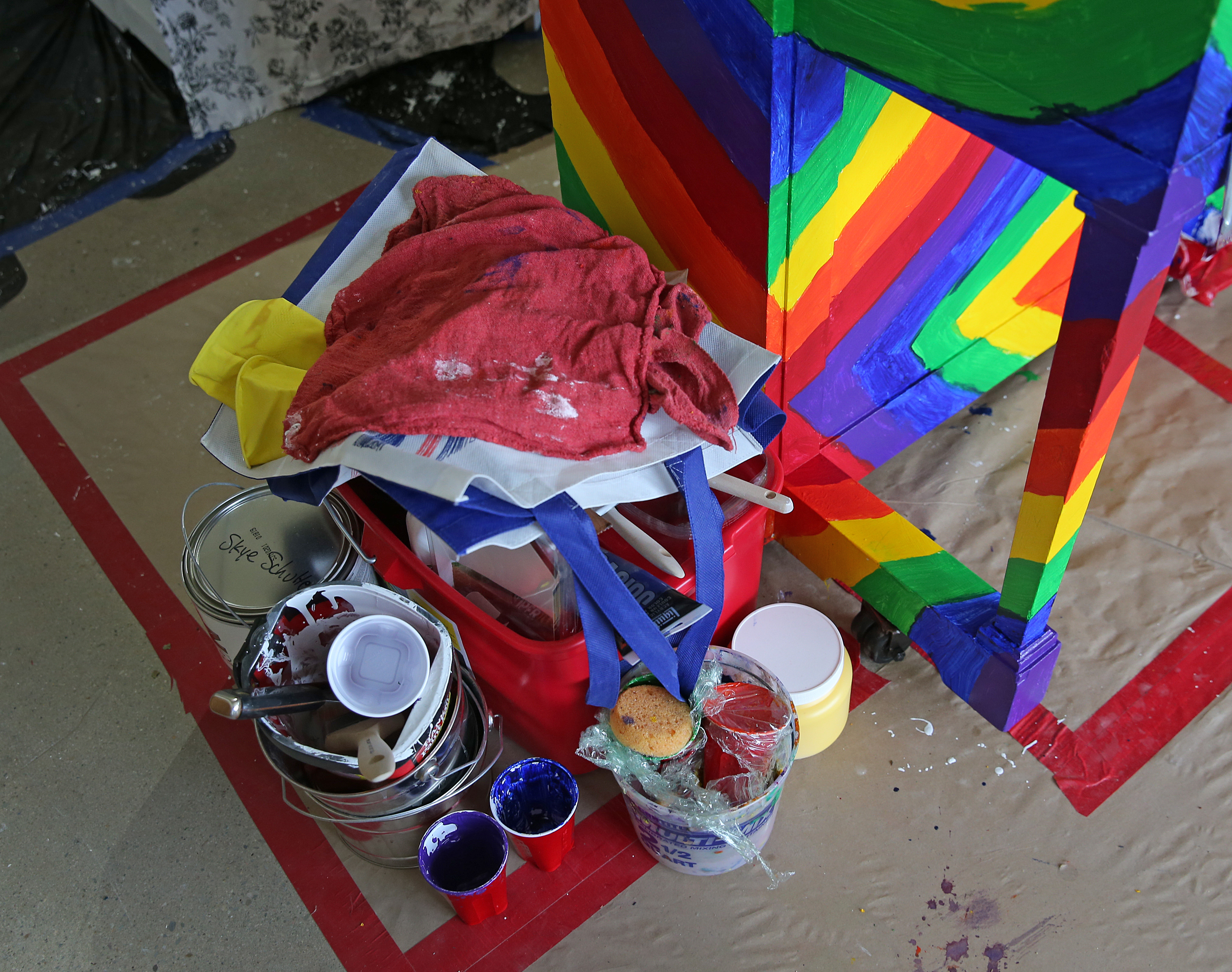 The tools of the trade are seen near a colorfully decorated piano.