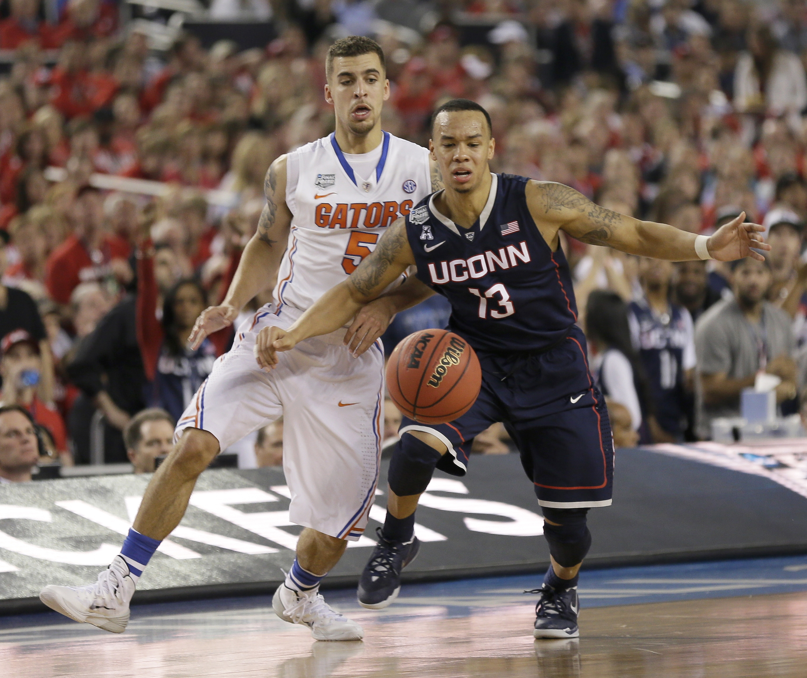 UConn guard Shabazz Napier, a Roxbury native, and Florida guard Scottie Wilbekin eyed a loose ball.