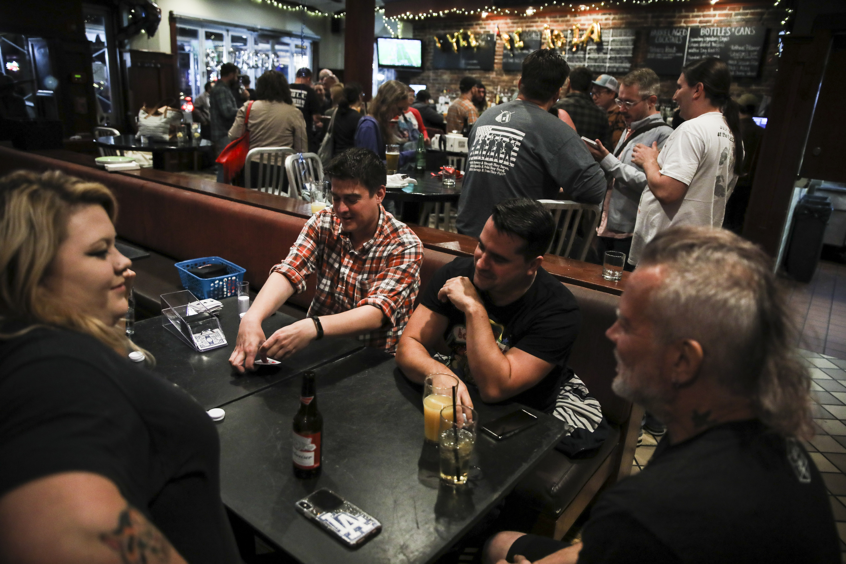 Customers played cards while commemorating the last night Common Ground has their doors open to the public.