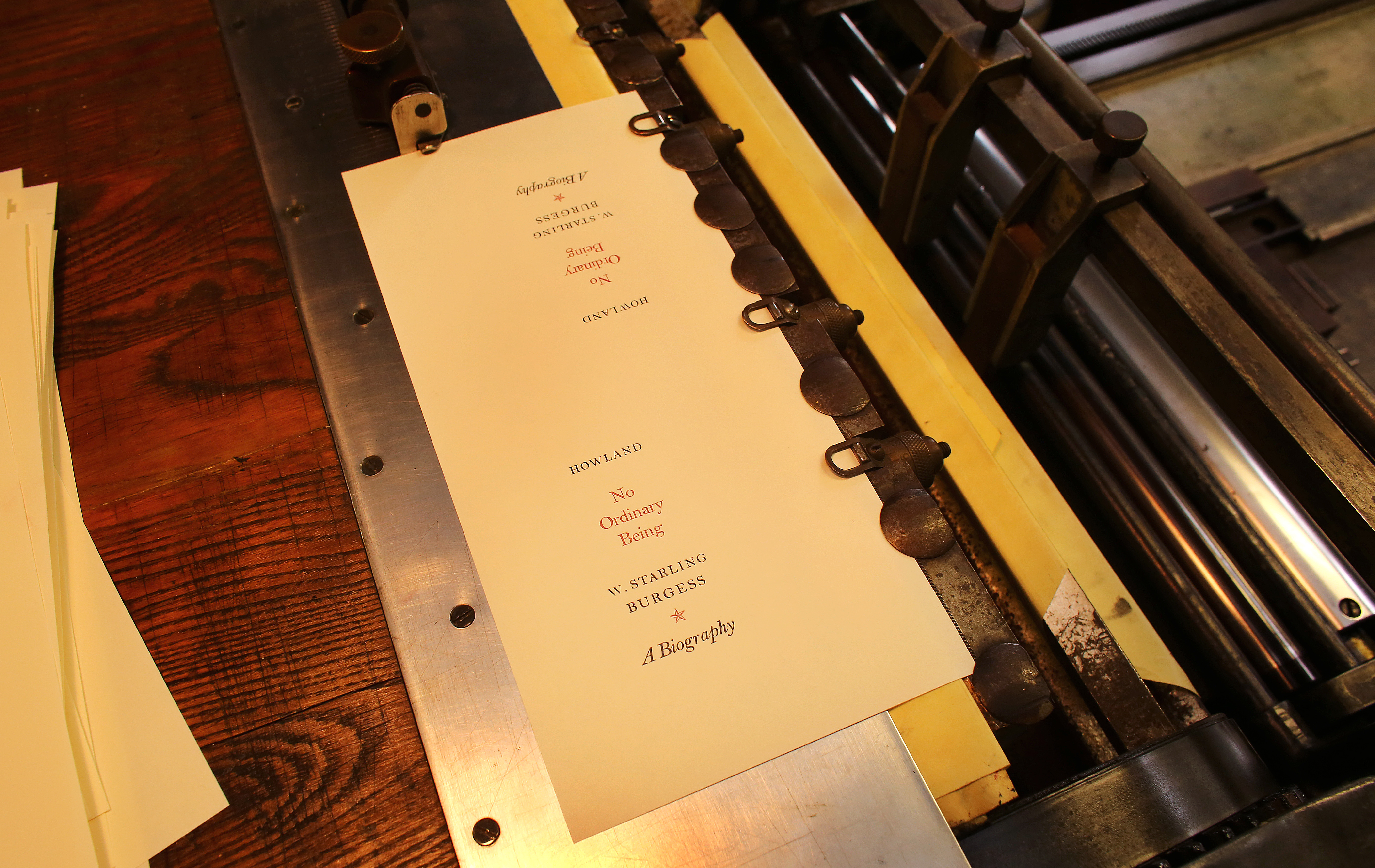 A paper label for a deluxe edition of "No Ordinary Being" sat in the grippers of the Vandercook Proof Press.
